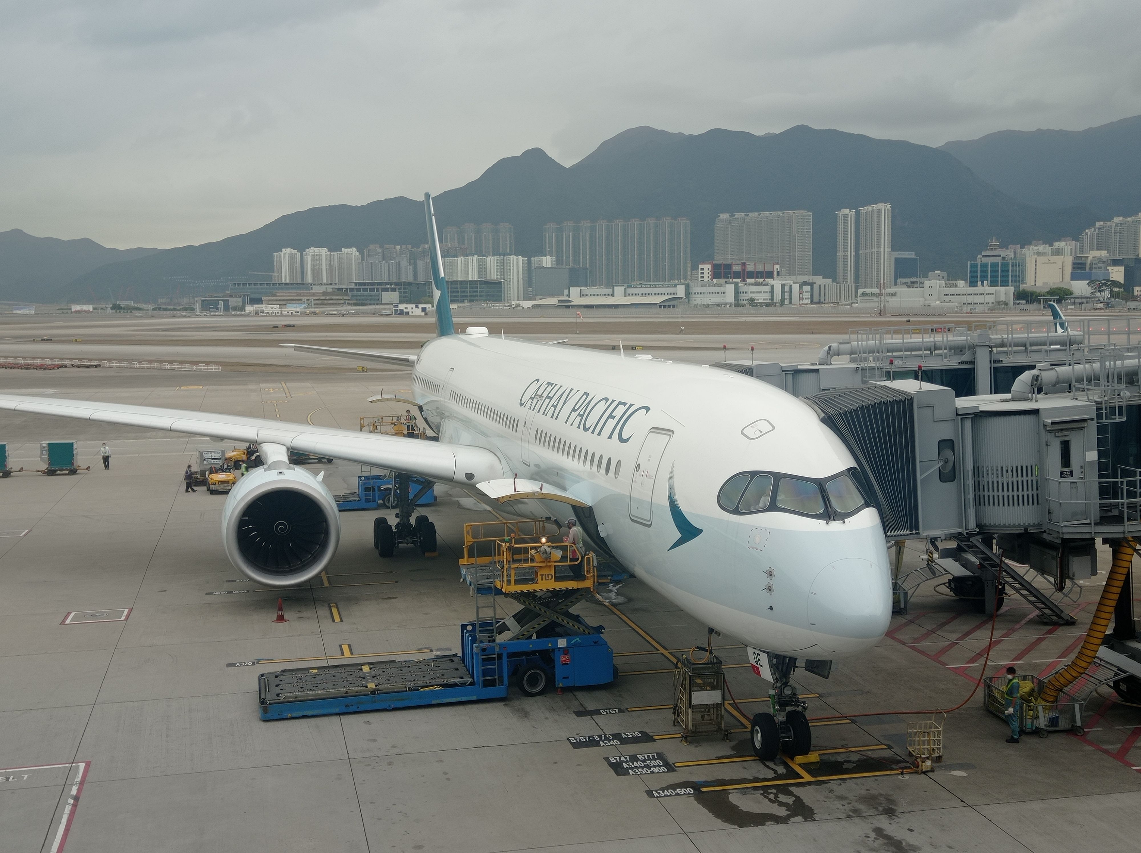A Cathay Pacific A350 parked at the gate.