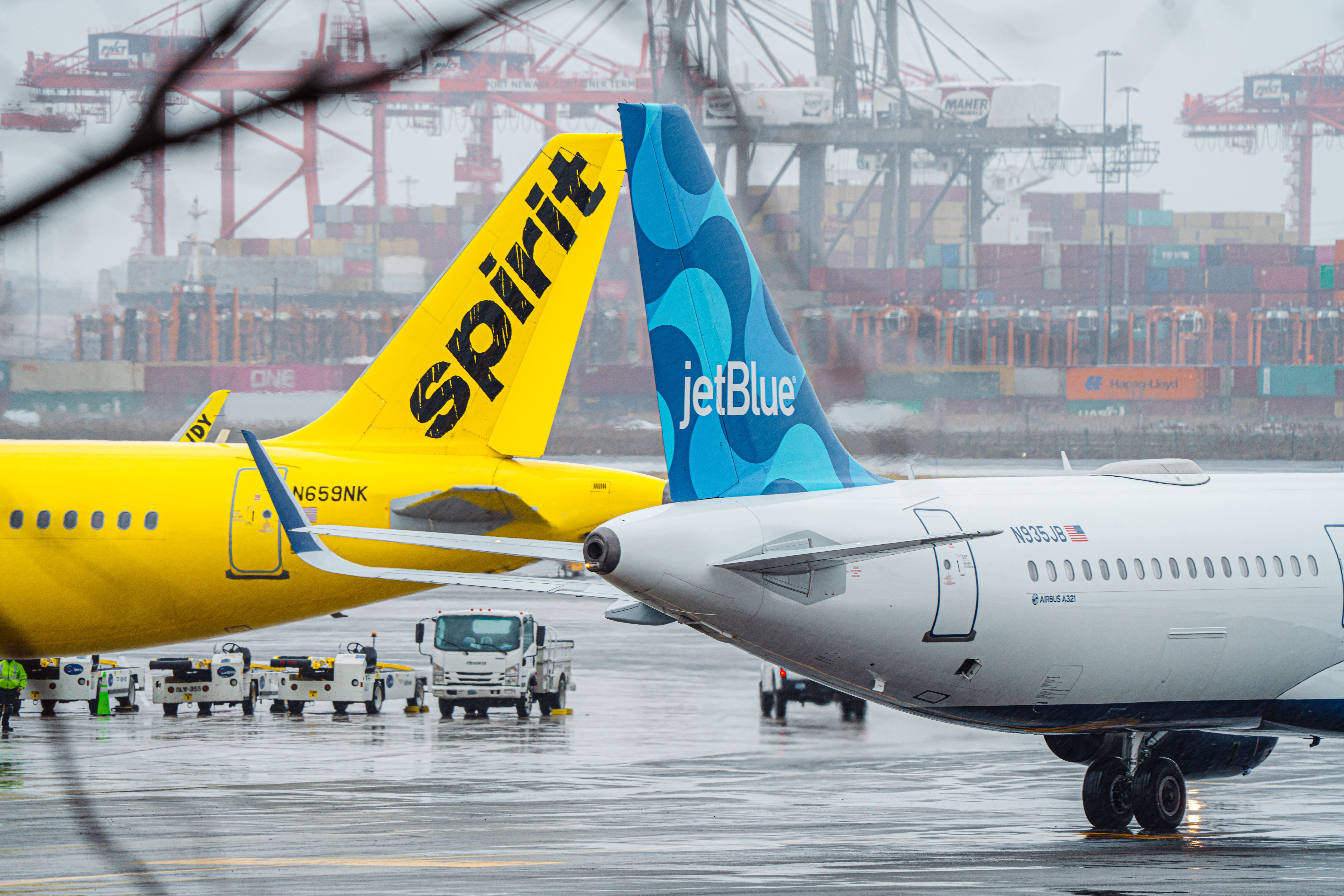 JetBlue and Spirit Airbus Aircraft at EWR on a rainy day.