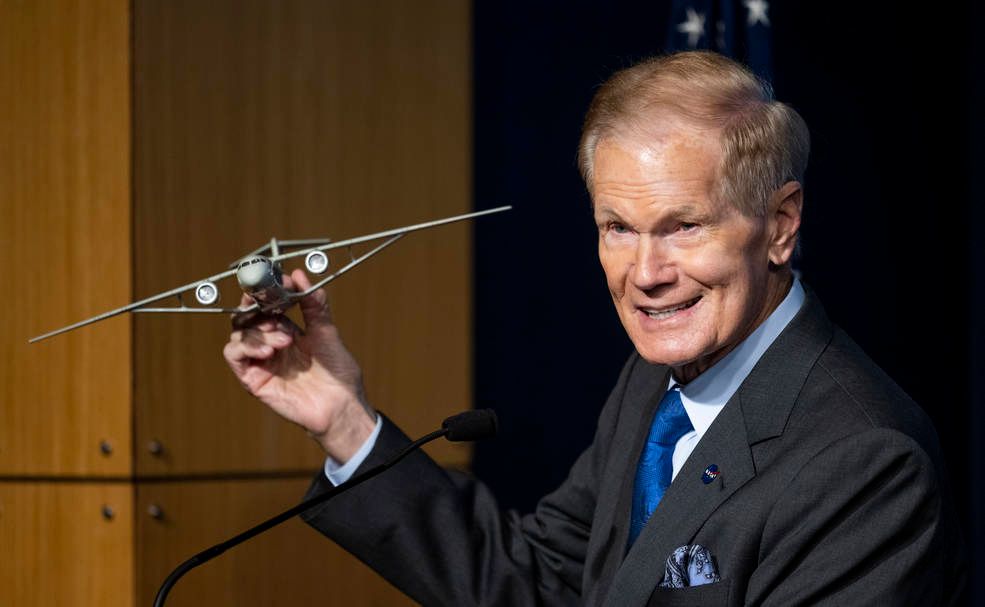 NASA administator Nelson holding up model plane