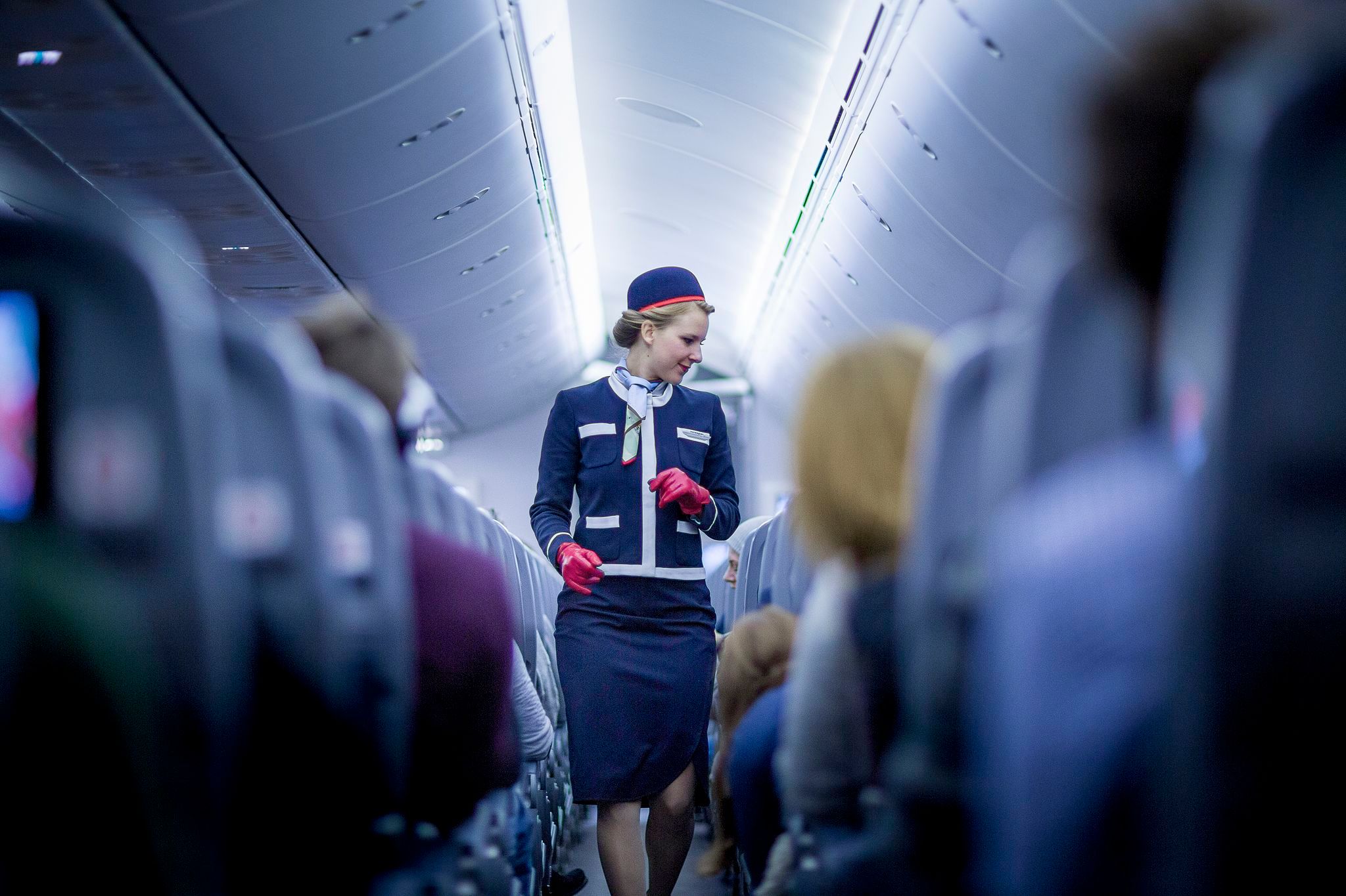 Norwegian flight attendant moving through the cabin.