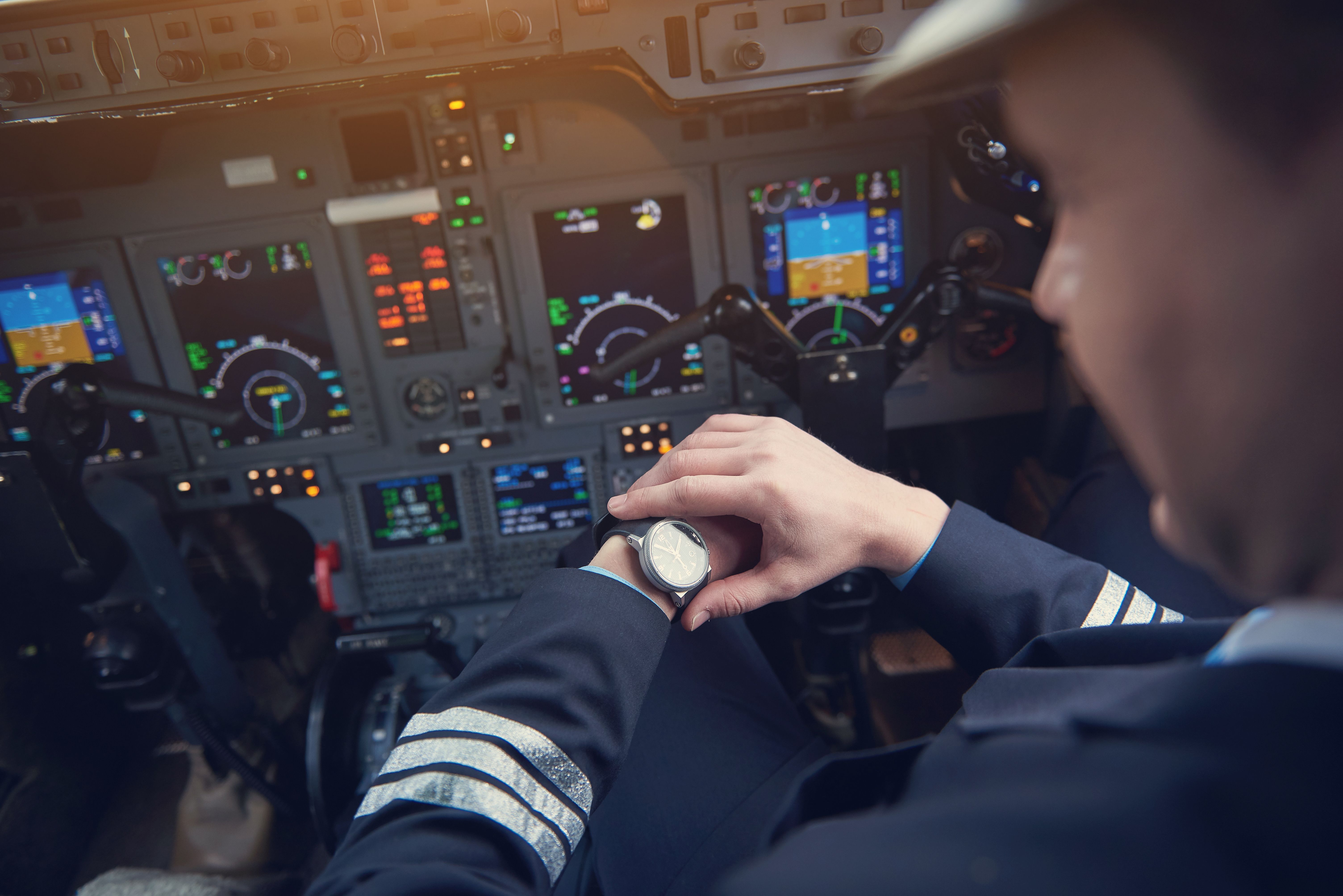 A first officer checks his watch.