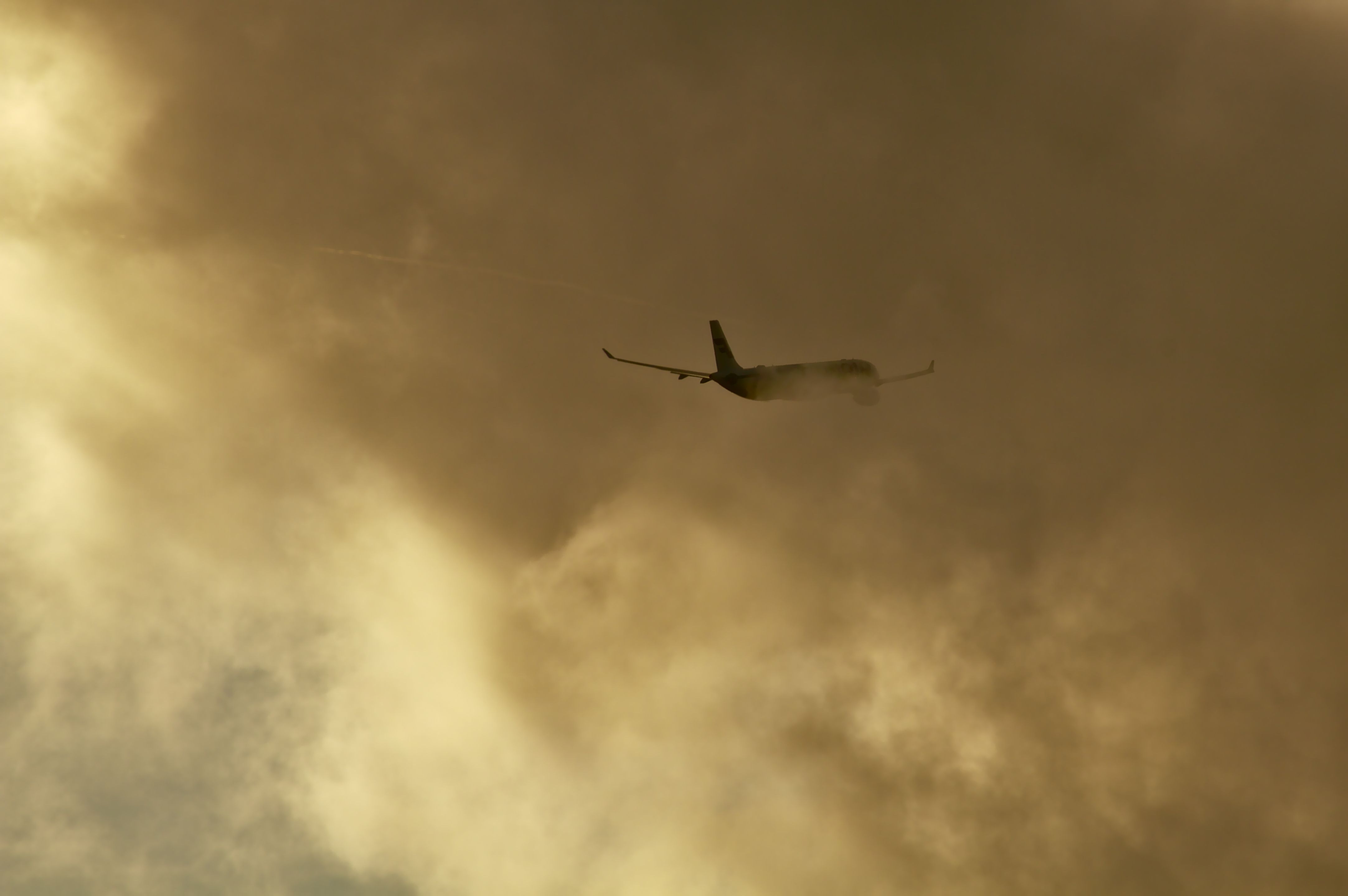 An aircraft climbing into a low cloud layer.