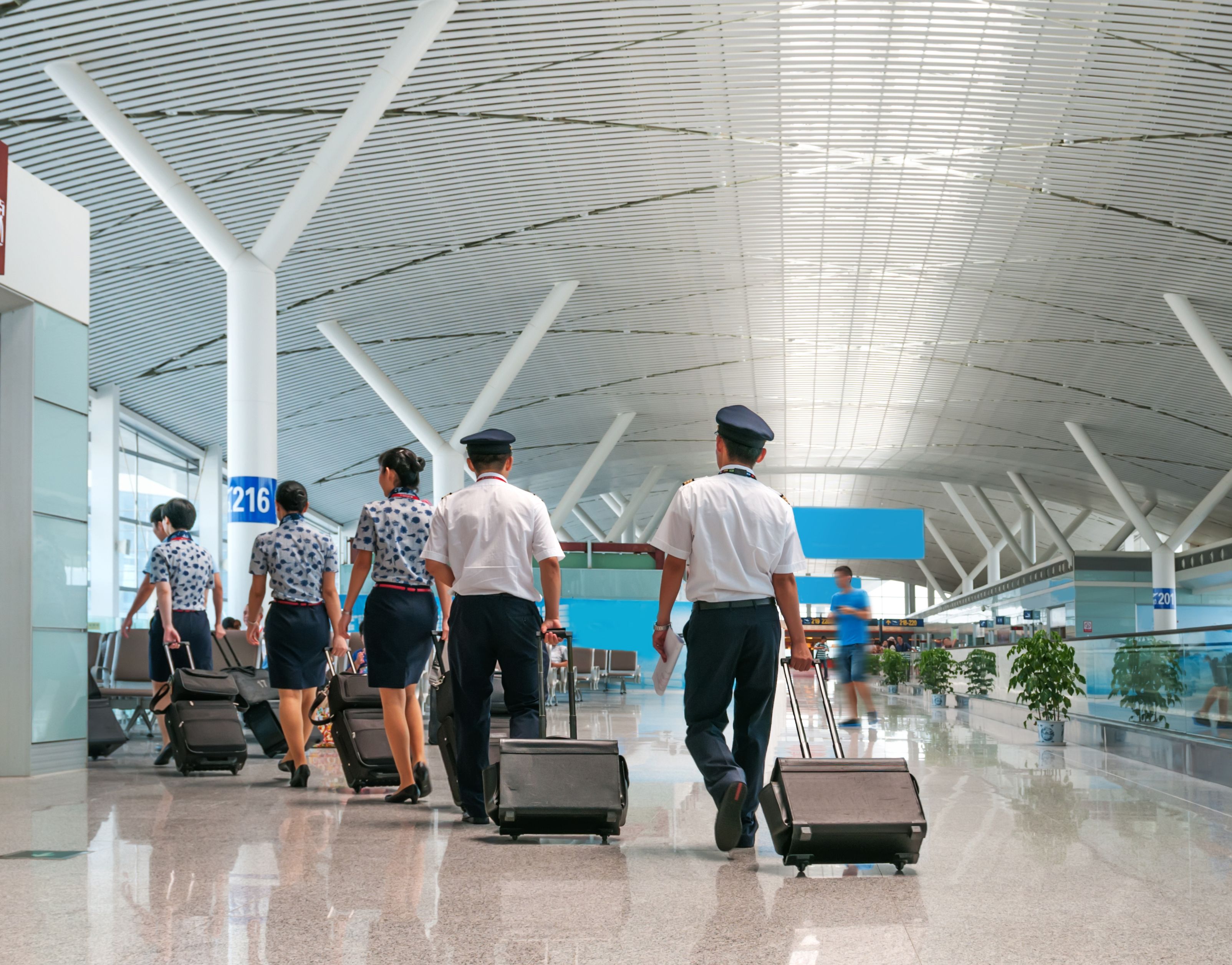 A crew walks towards their boarding gate.