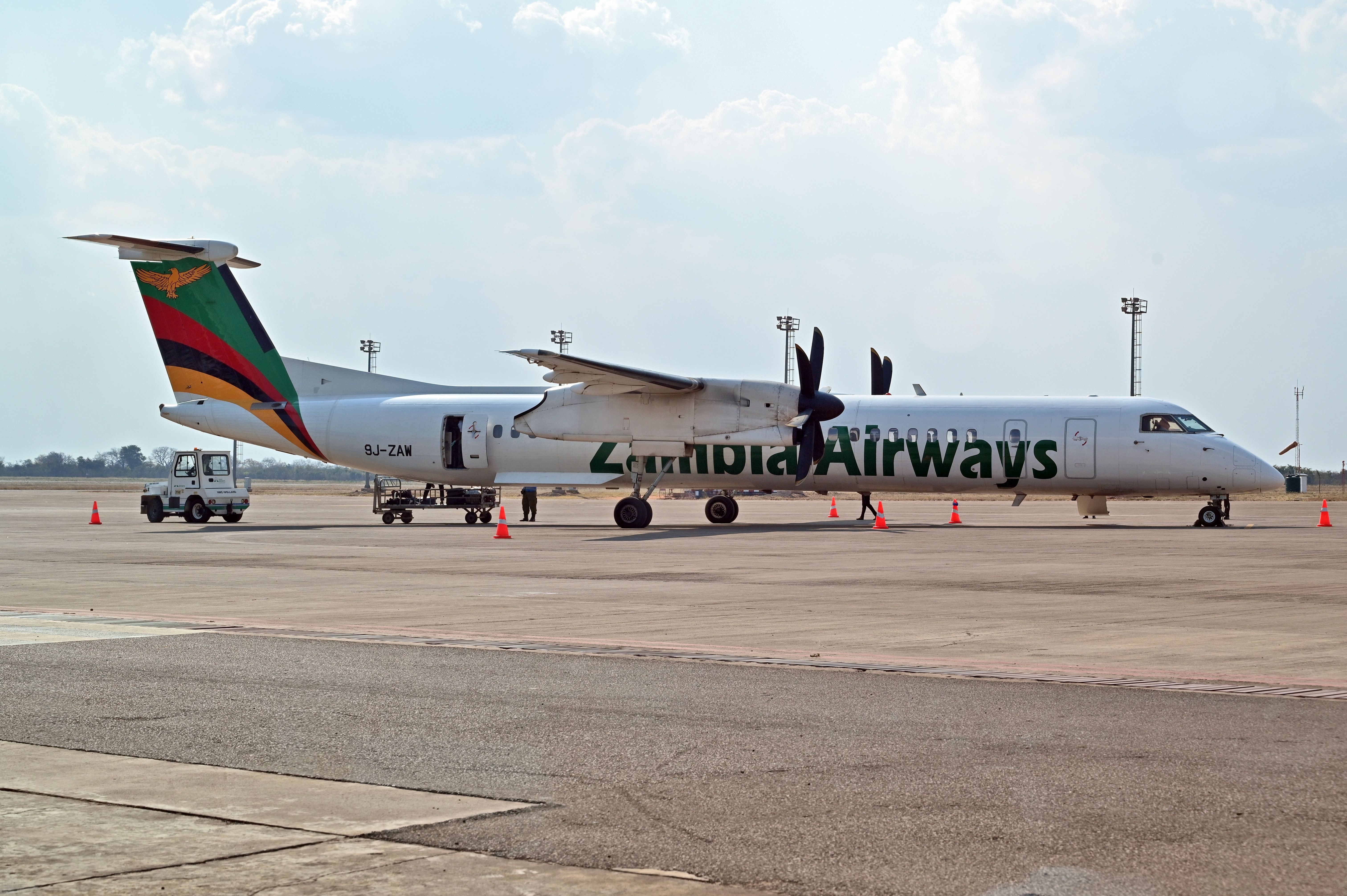 A Zambia Airways aircraft parked on an airport apron.