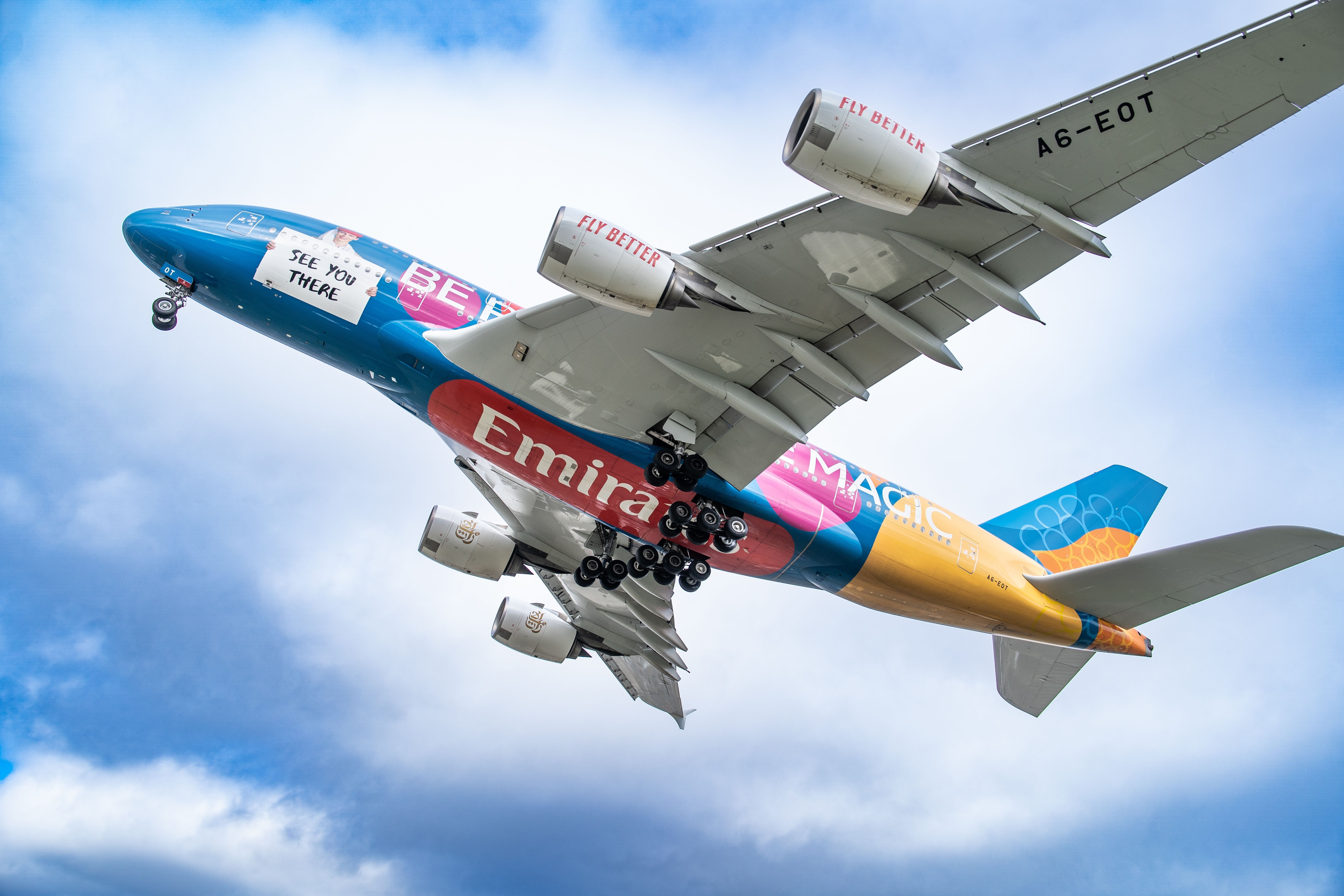 An Emirates Airbus A380 in Dubai Expo 2020 livery flying in the sky.