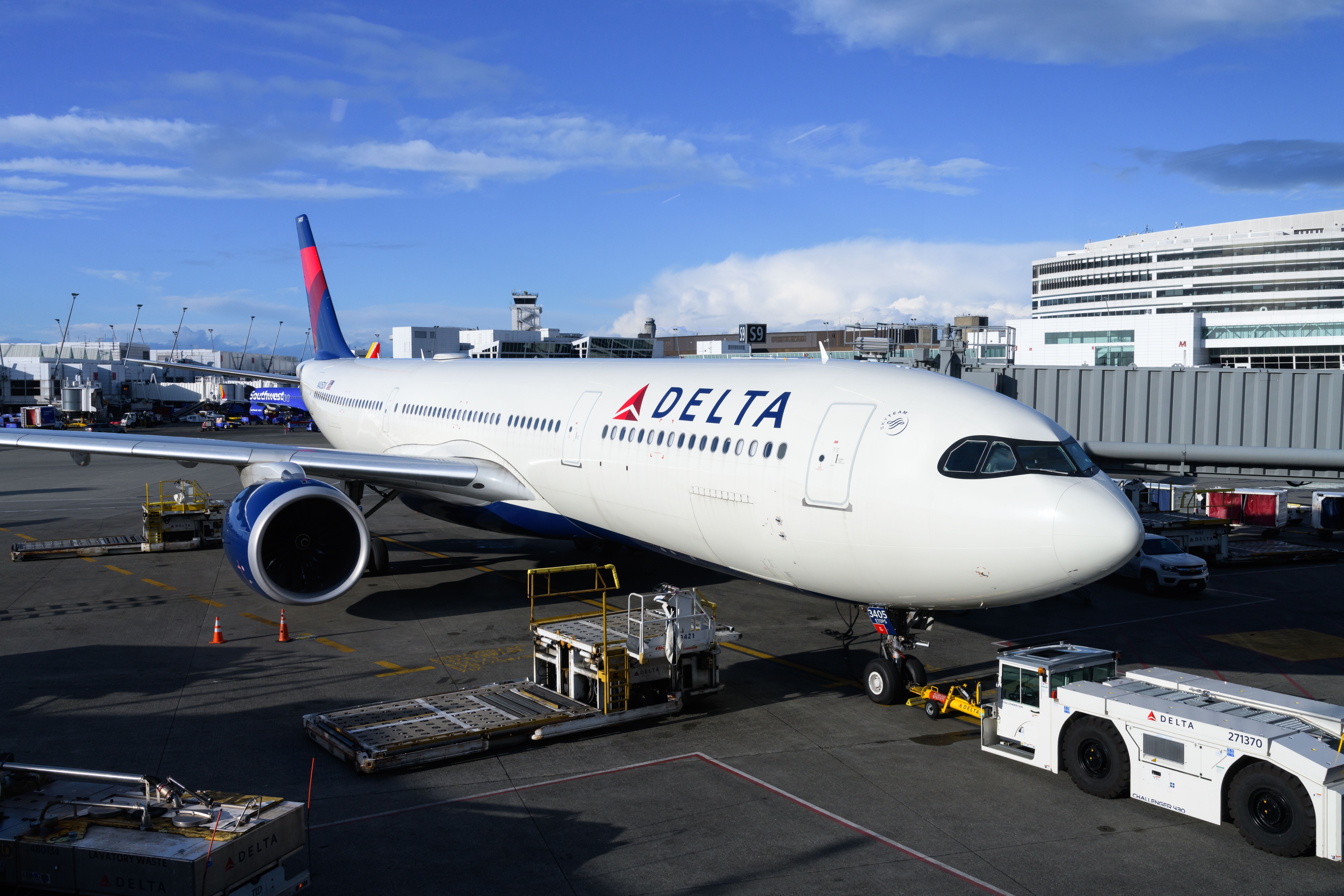 Delta Airlines Airbus A330-900 aircraft at Seatac south terminal with tug