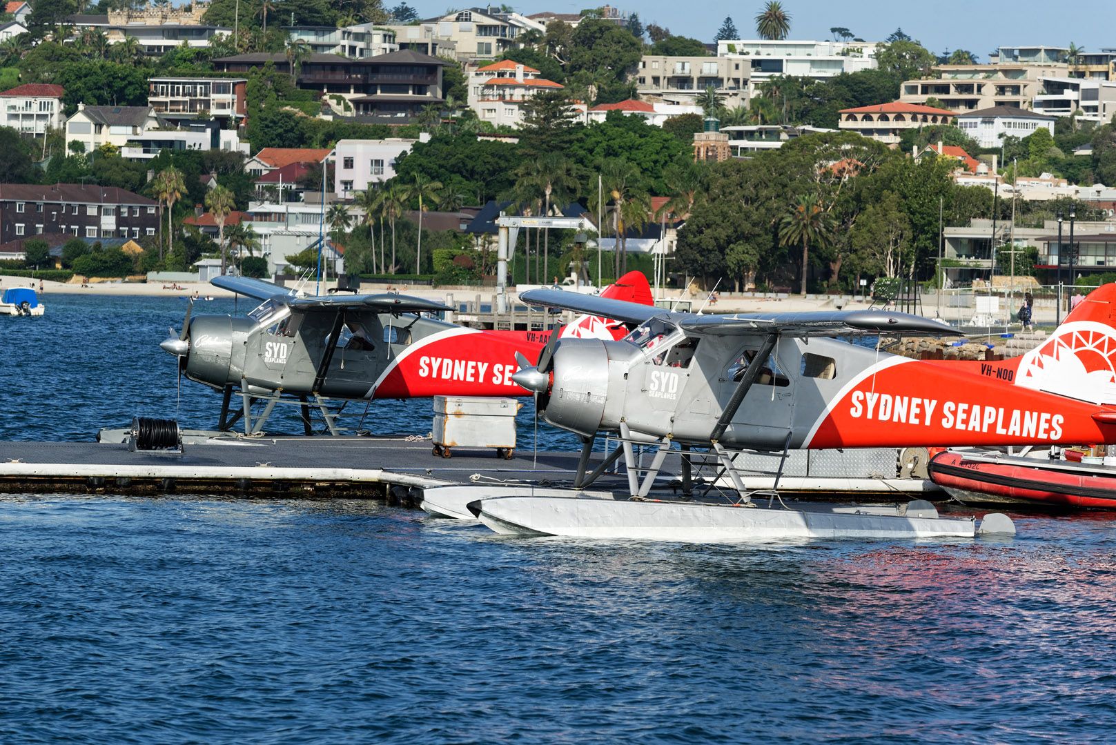 Photo of multiple Sydney Seaplanes parked at a dock.
