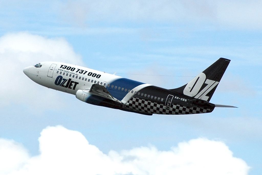 An OzJet Boeing 737 flying in the sky.