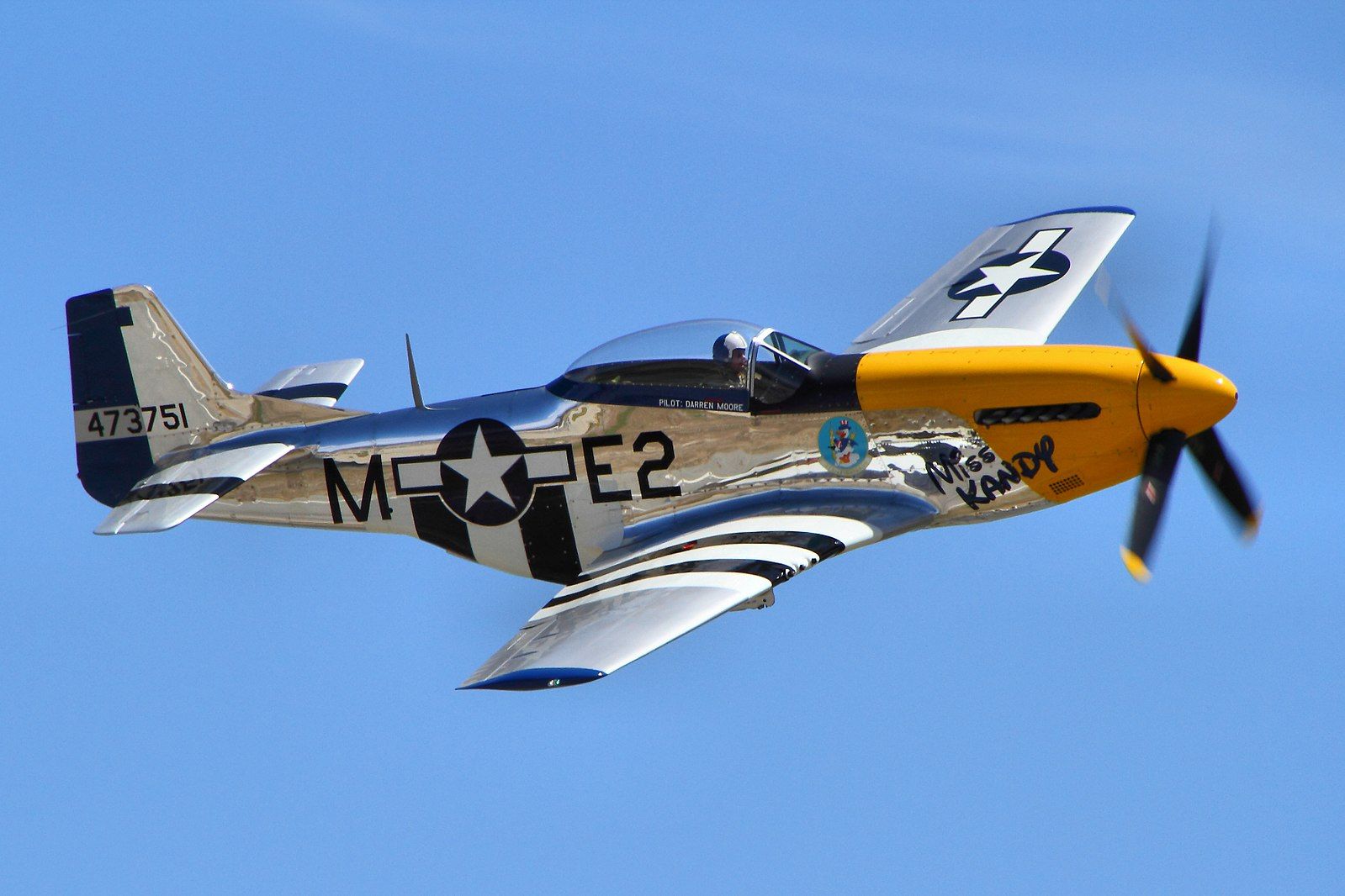 A P51 Mustang flying in the sky.
