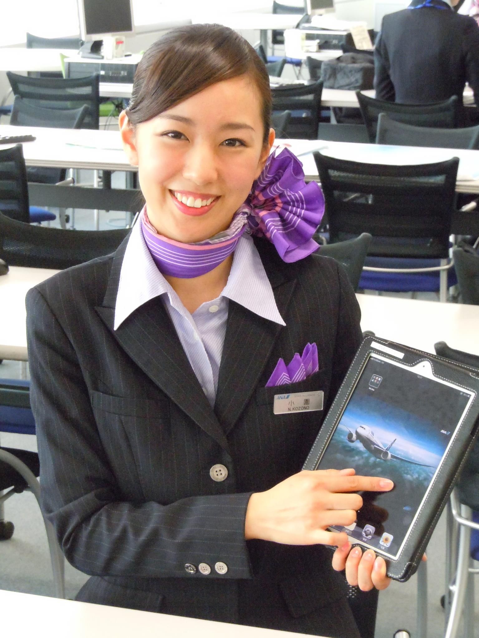 An All Nippon Airways flight attendant using a tablet.