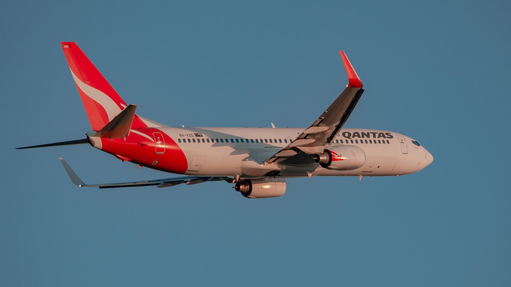 A Qantas aircraft flying in the sky.