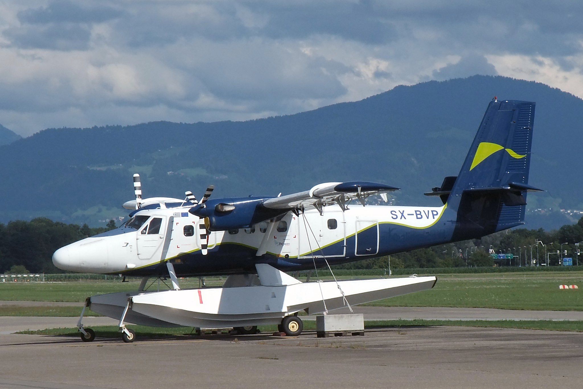 A De Havilland Canada DHC-6-300 Twin Otter parked at an airfield.