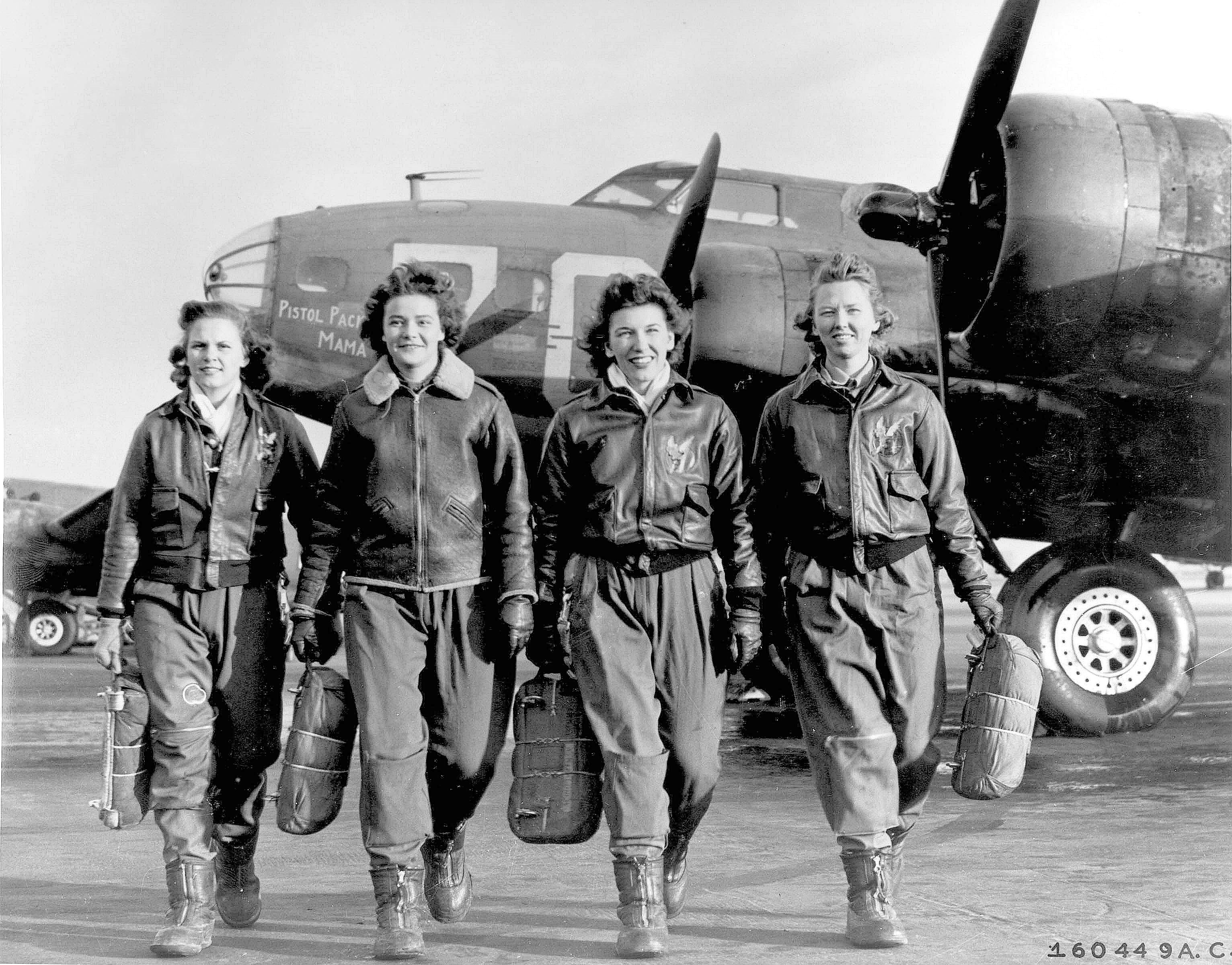 female pilots walking in front of an aircraft.