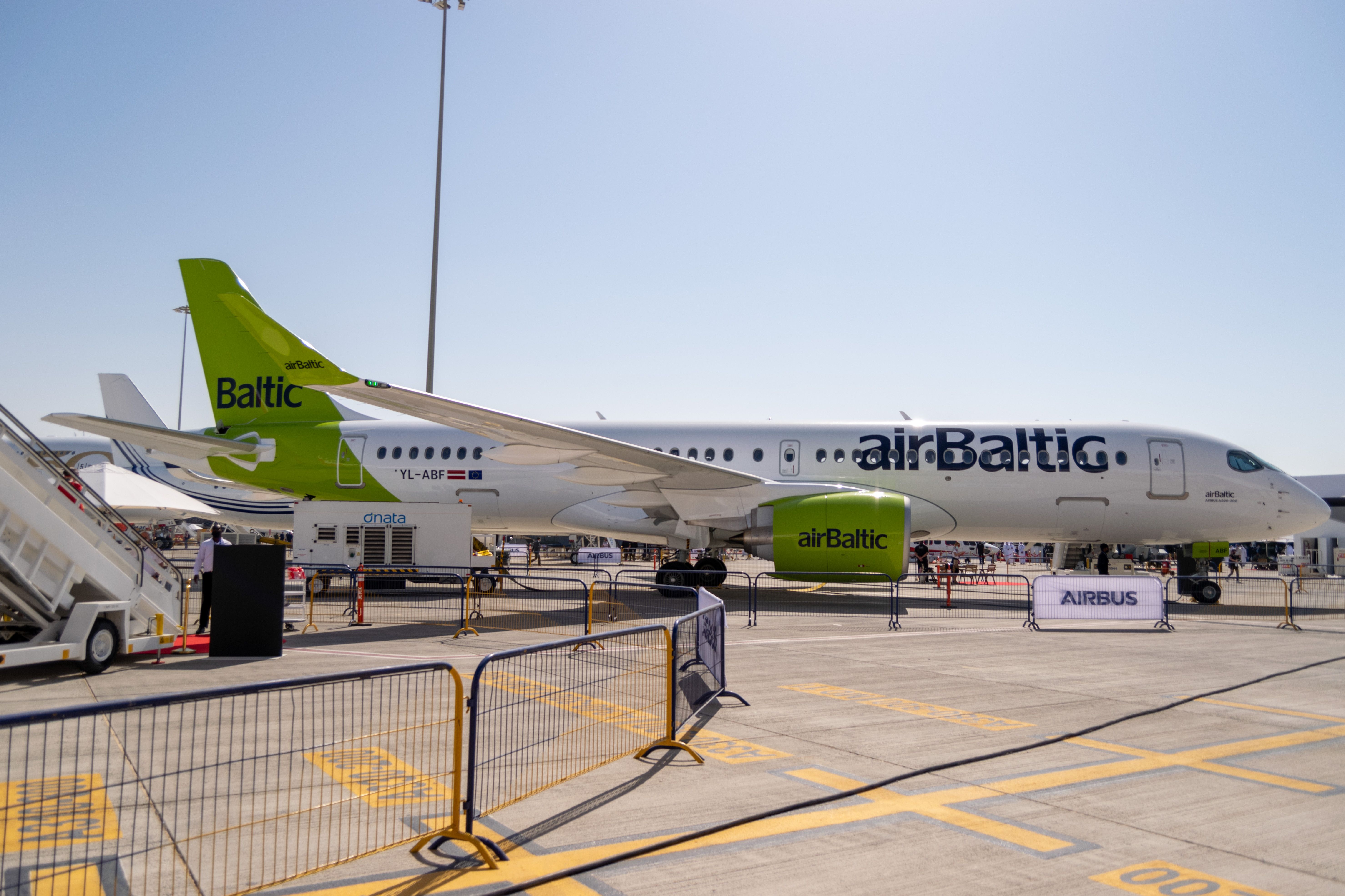 An Air Baltic Airbus A220 parked on an apron.