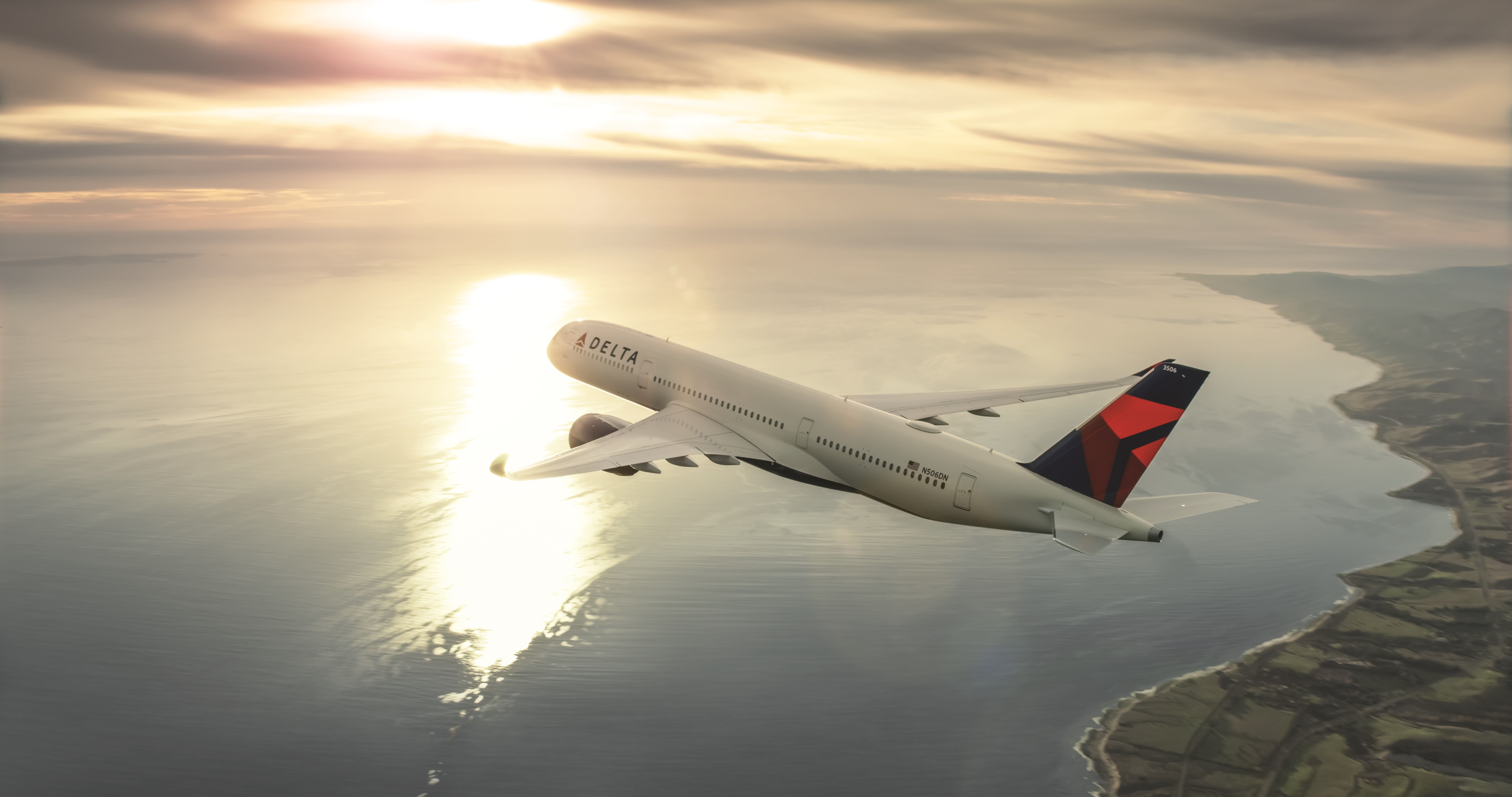 A Delta Air Lines Airbus A350 flying over a coastal area.