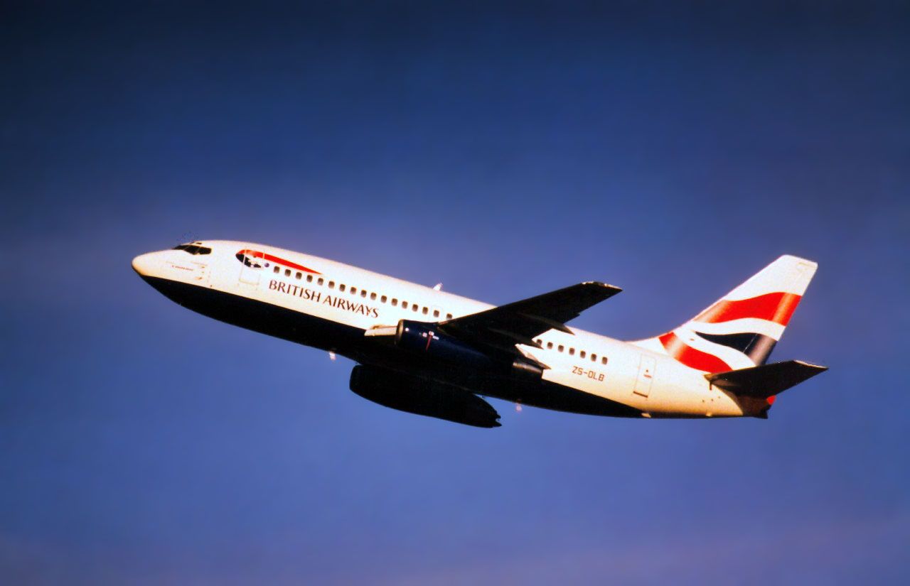 A British Airways - Comair B737-200, registration ZS-OLB, flying in the sky.