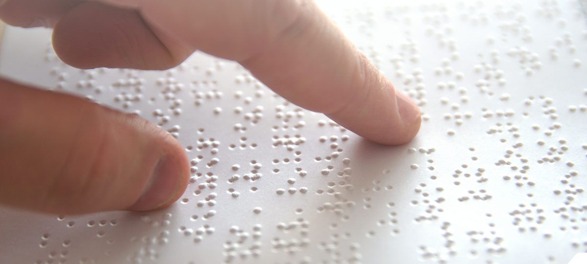 Someone's finger on a braille document.
