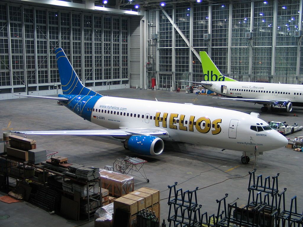 A Helios 737-300 parked at an airport.