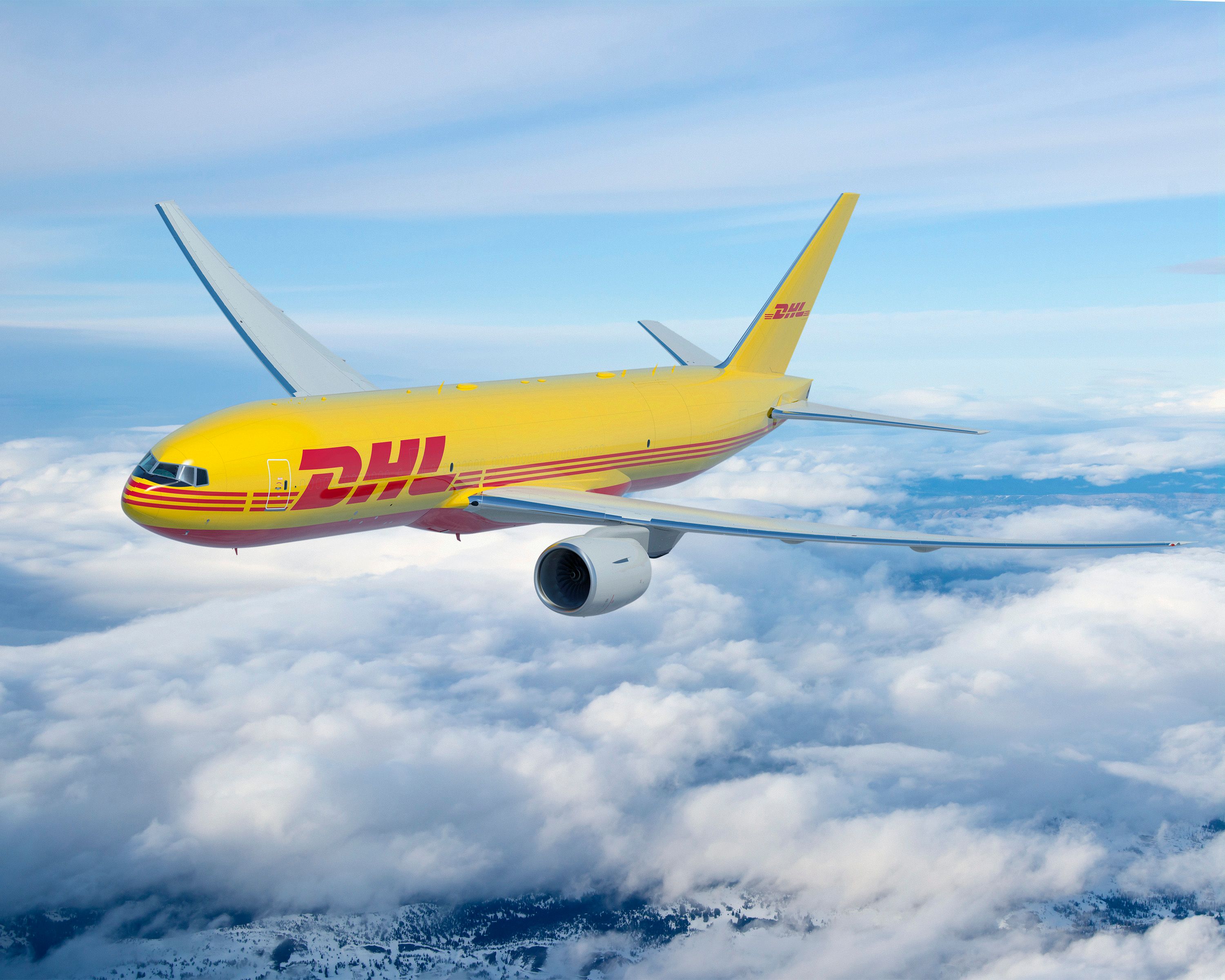 A DHL Boeing 777 Freighter Aircraft flying in the sky.
