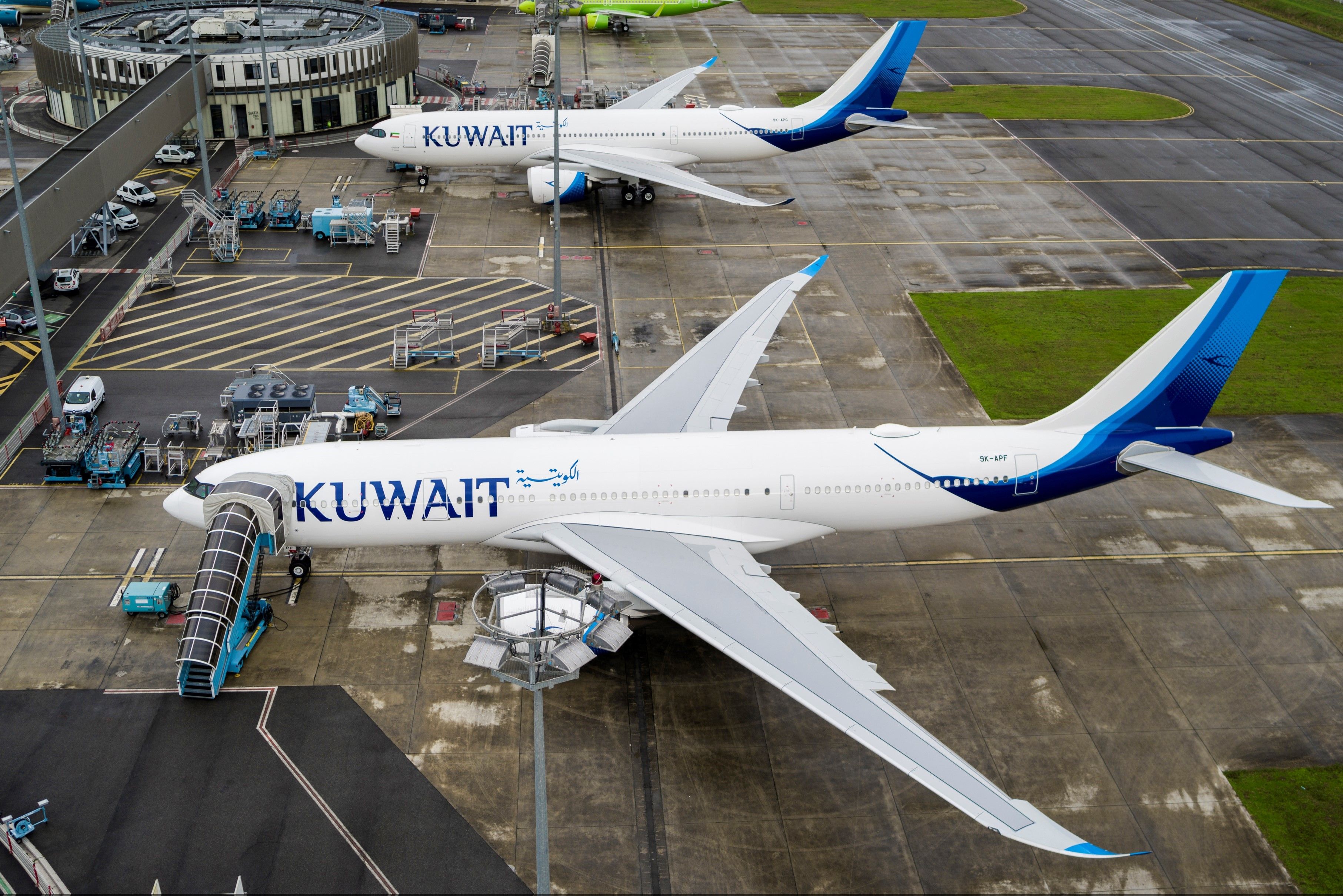 A Kuwait Airways Airbus A330neos parked at their gates.