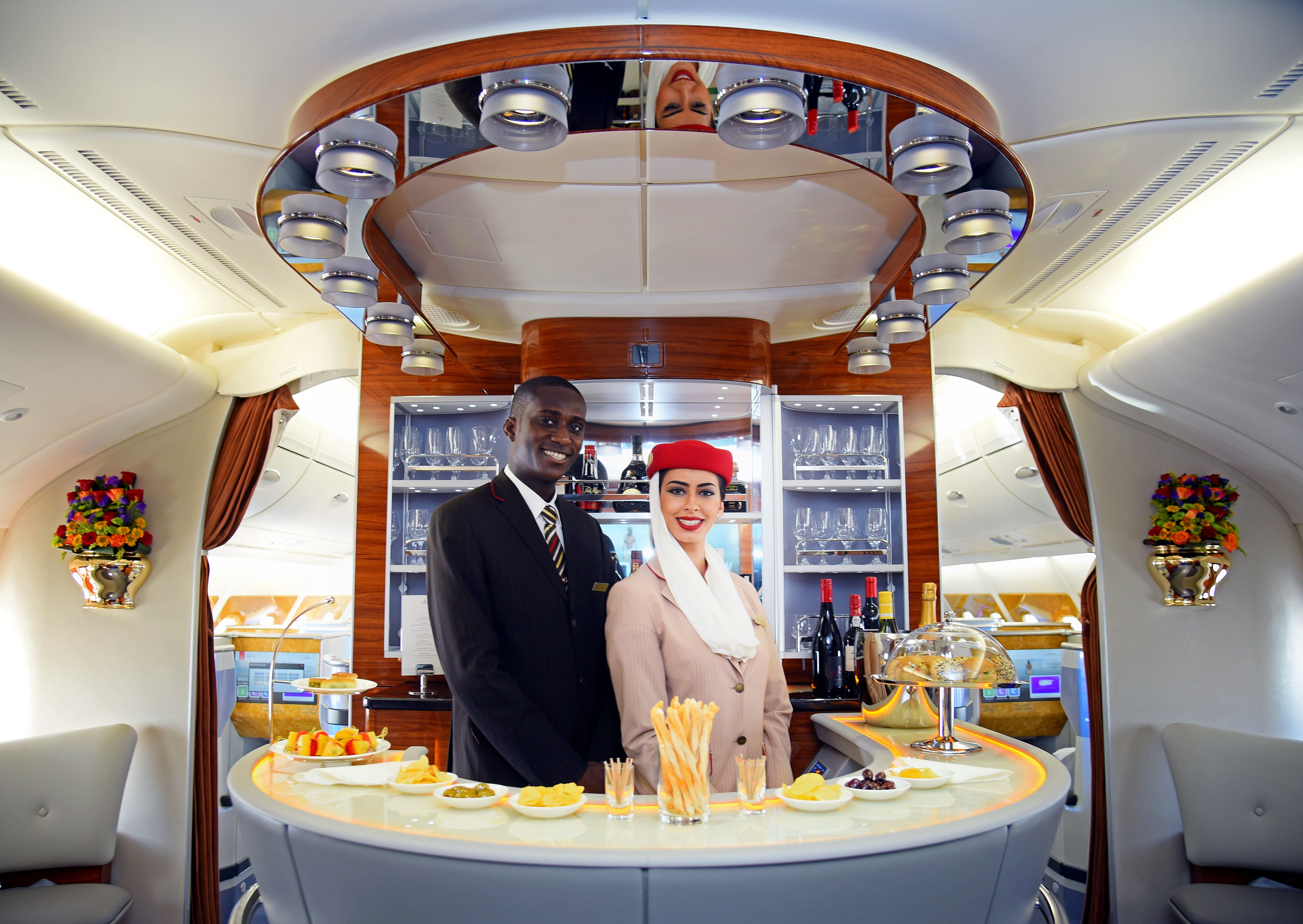 Cabin crew standing in the Emirates A380 upper deck lounge.
