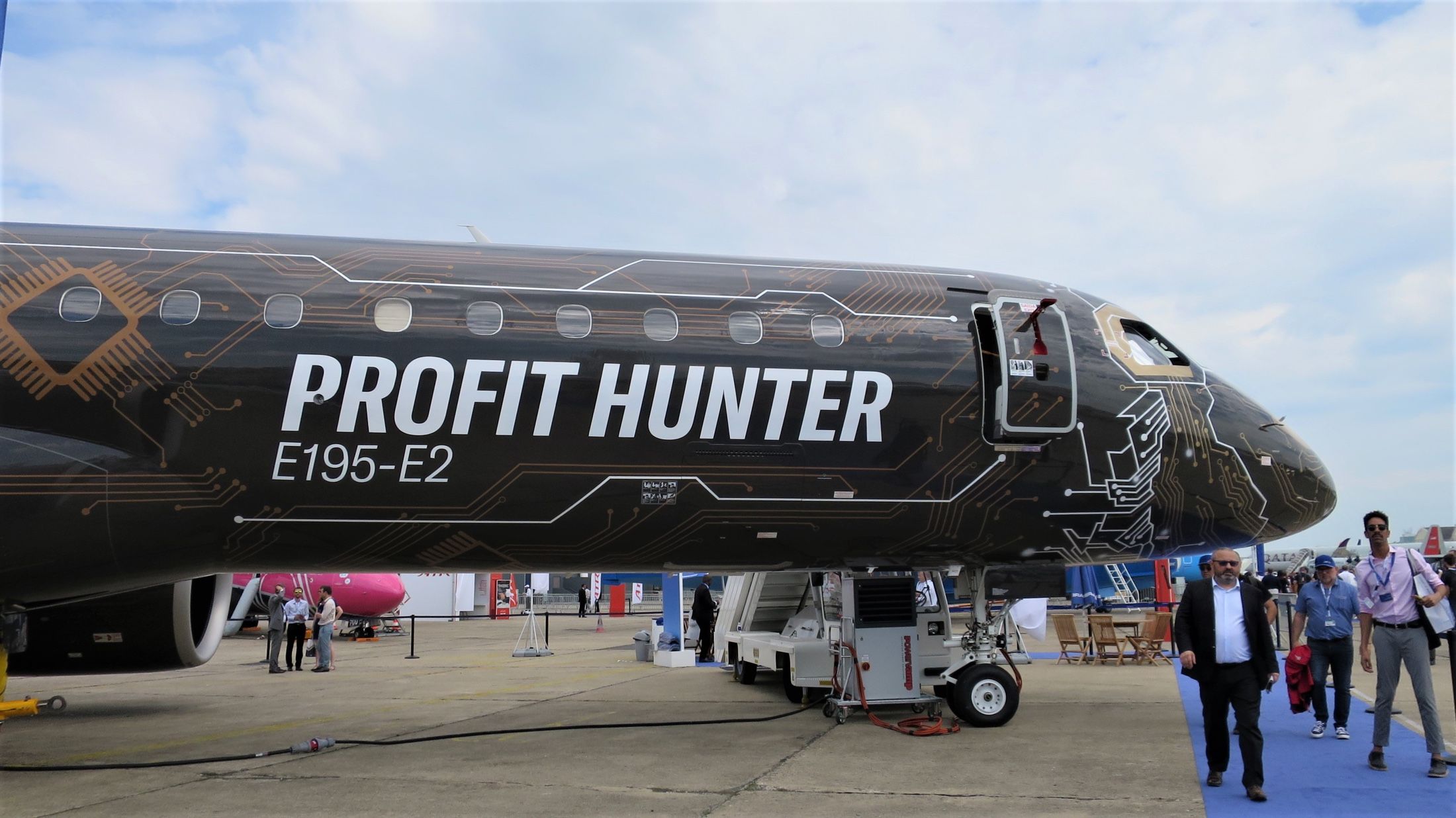 An Embraer E195-E2 in Profit Hunter livery on display at an air show.