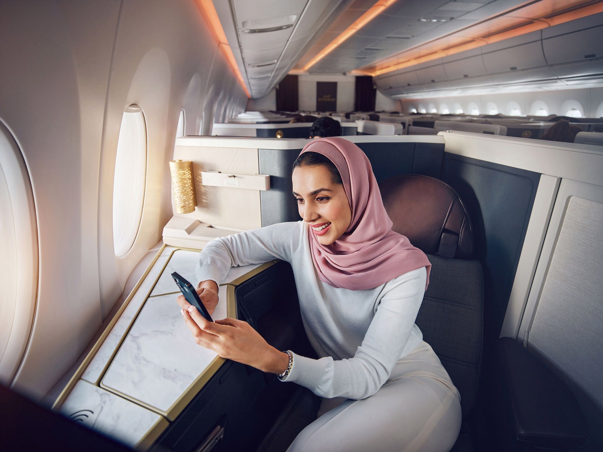 Etihad Airways Business Class with guest taking advantage of Etihad's unlimited Wi-fly