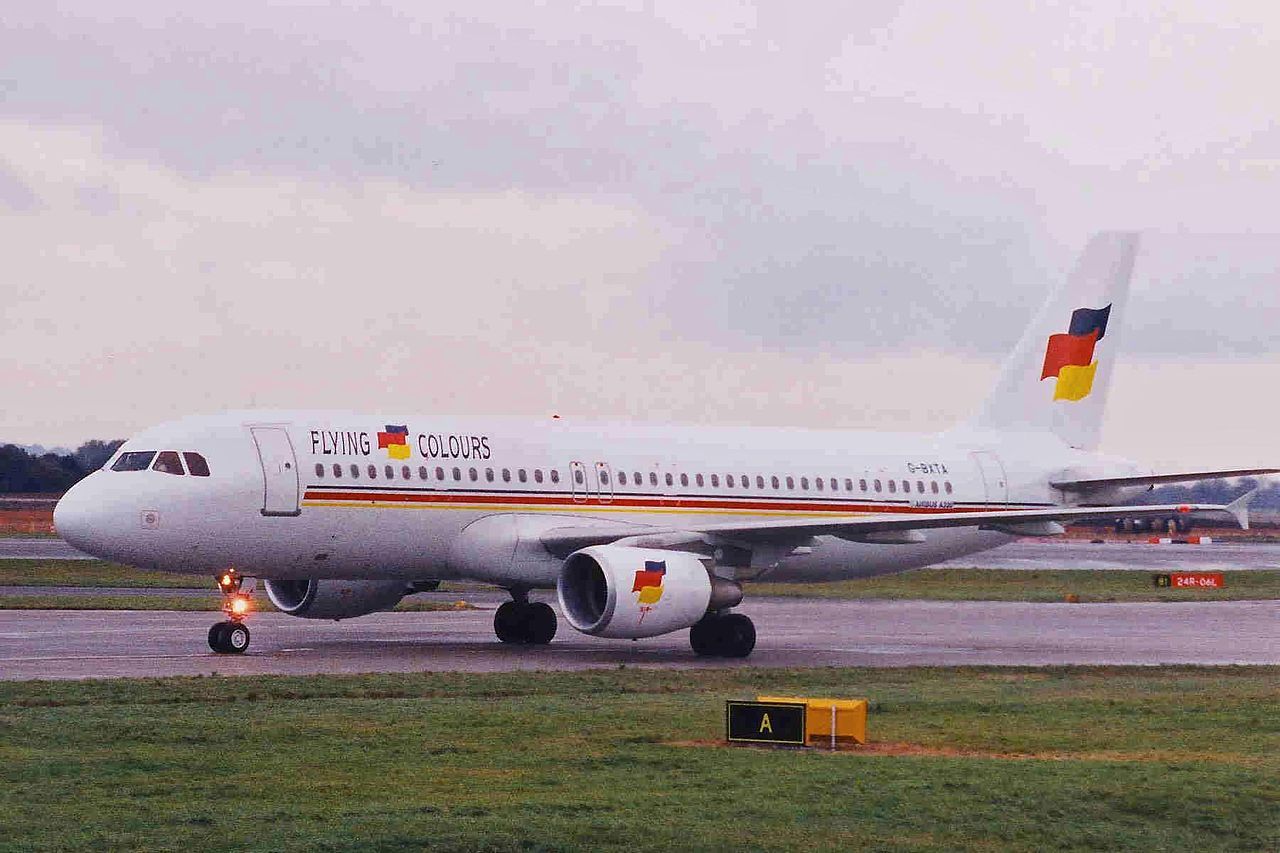 A Flying Colours Airbus A320, registration G-BXTA on the runway at Manchester Airport.