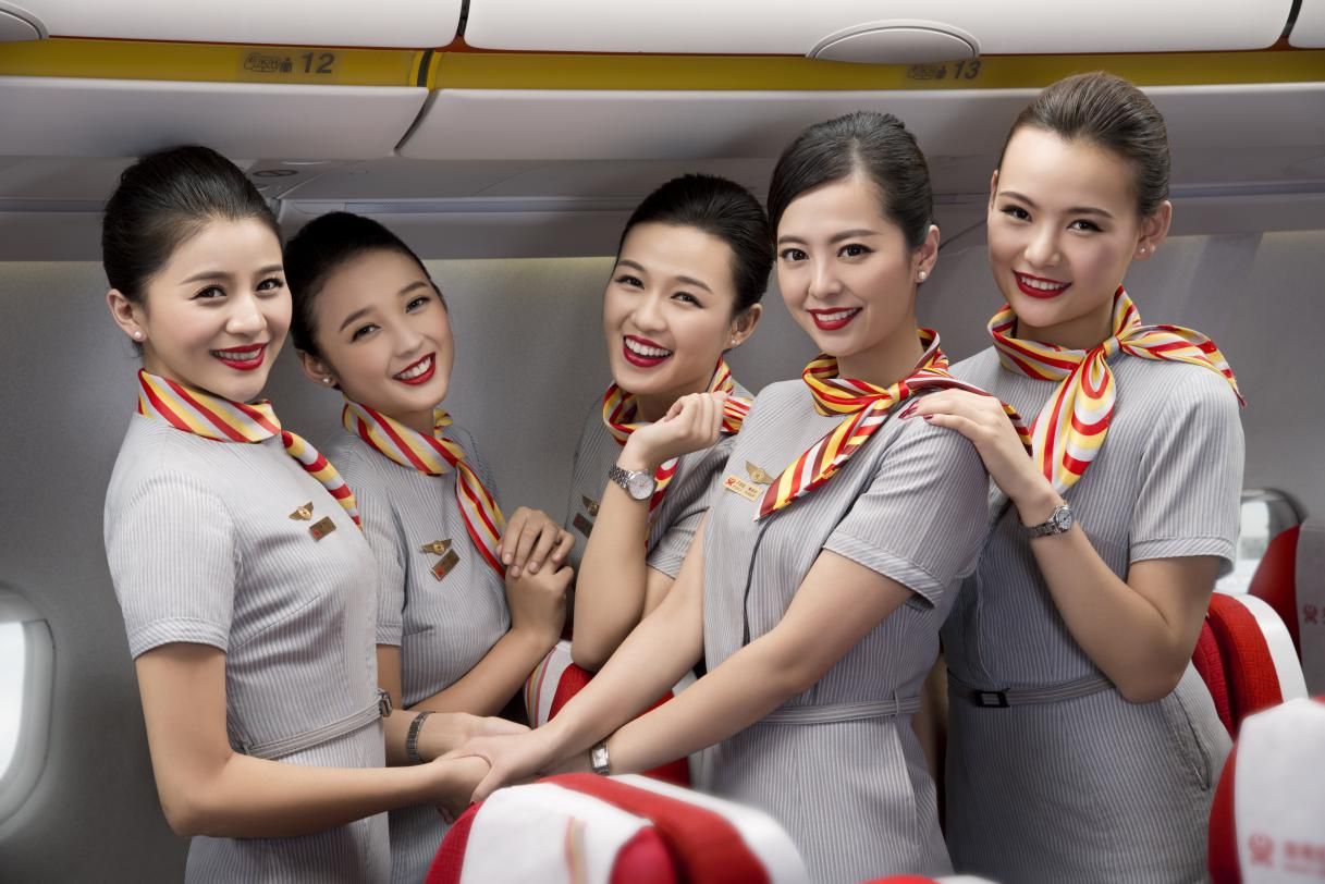 A group of Hainan Airlines cabin crew in the aircraft cabin.