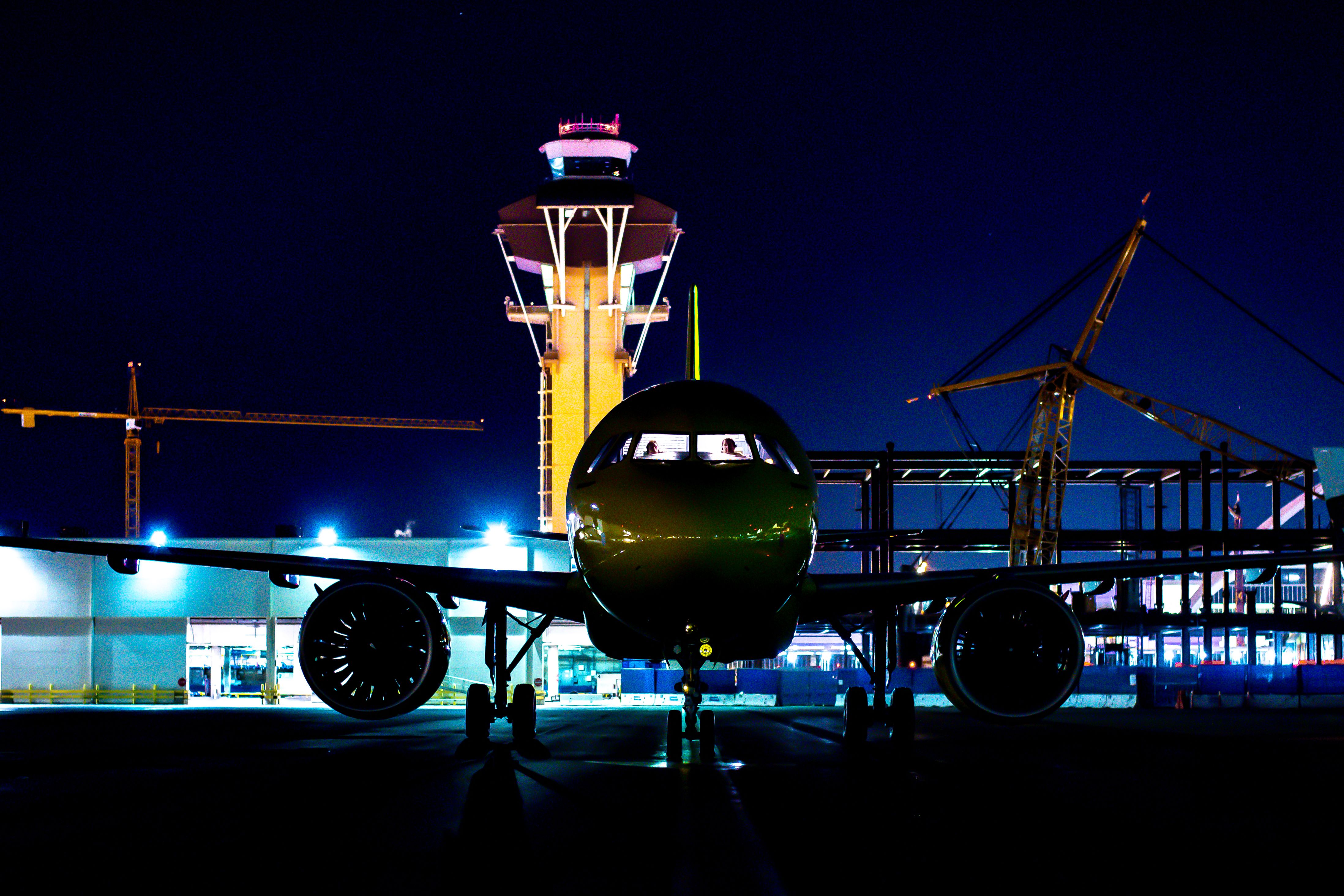 Los Angeles international airport tower with plane at night