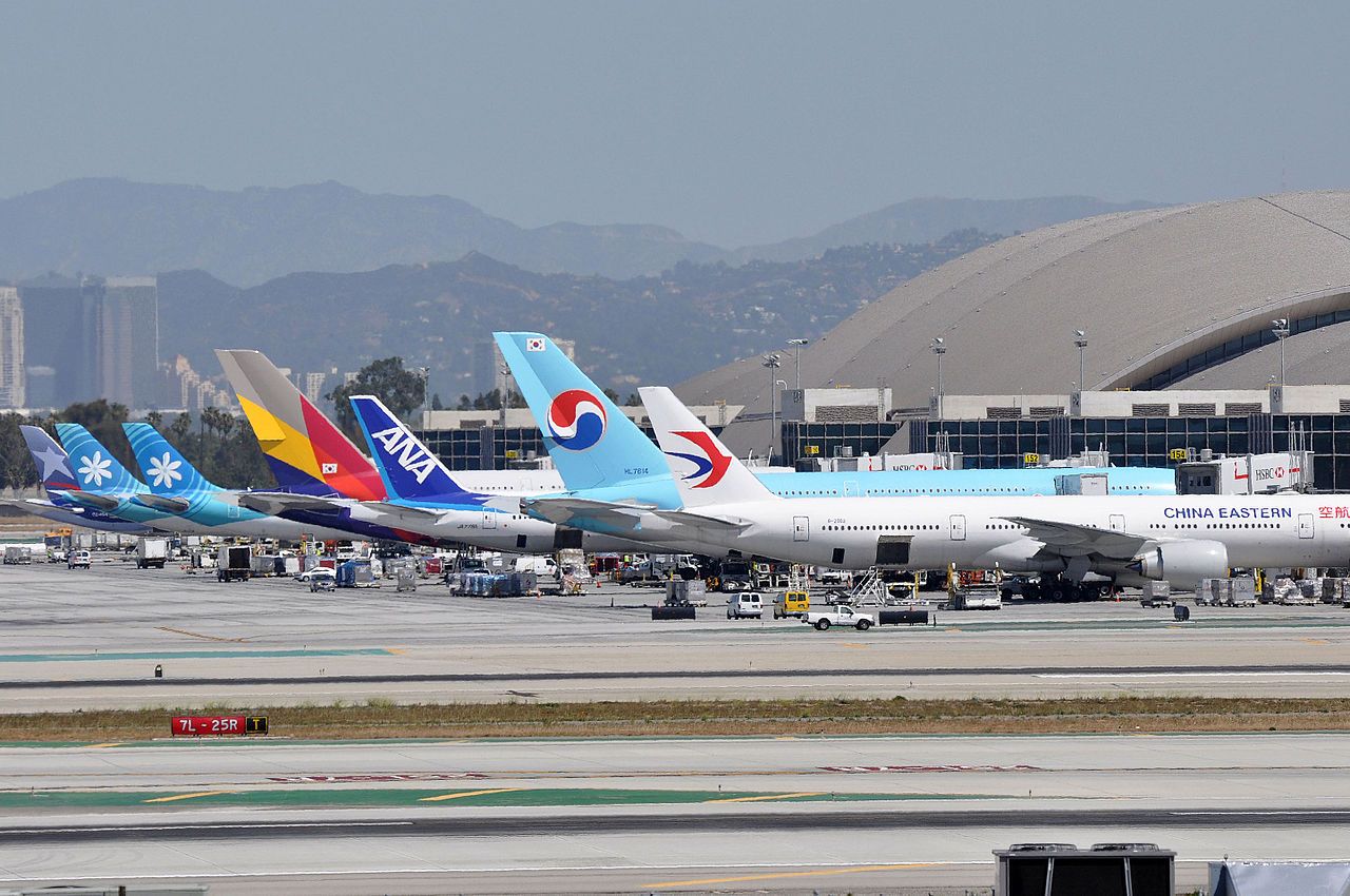 Many foreign aircraft lined up at gates at LAX.