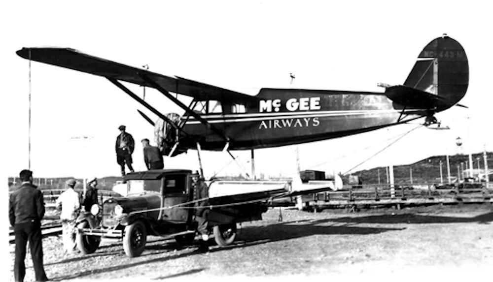 A McGee Airways Stinson aircraft being moved.