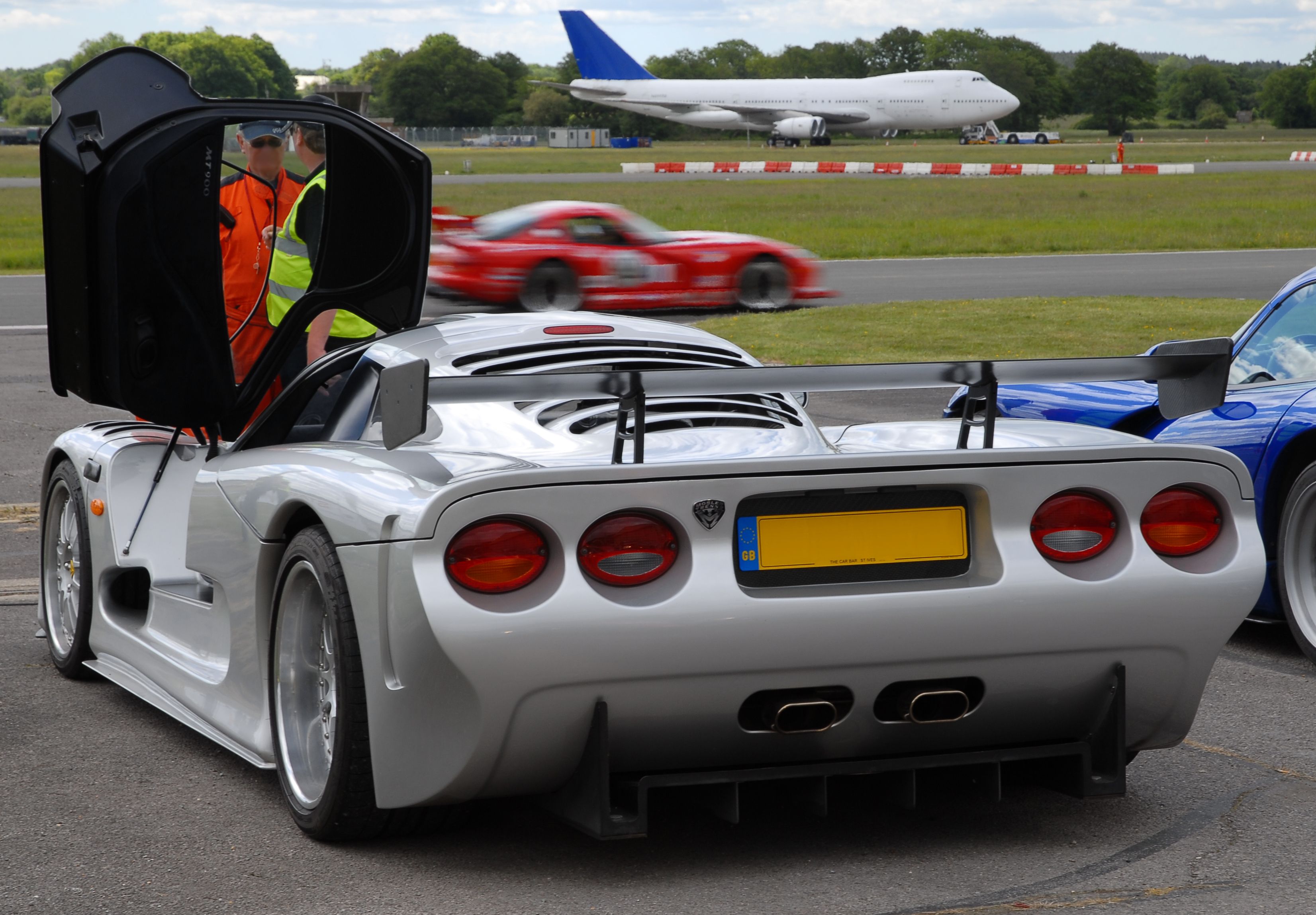 Exotic supercars and a Boeing 747 at the Dunsfold aerodrome.