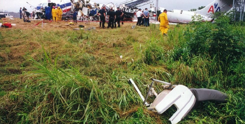 Workers looking through the wreckage of American Airlines Flight 1420. 