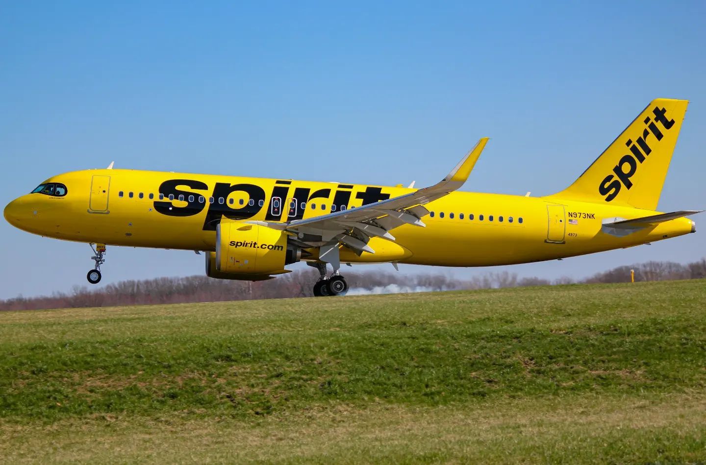 A Spirit Airlines aircraft as it lands on the runway.