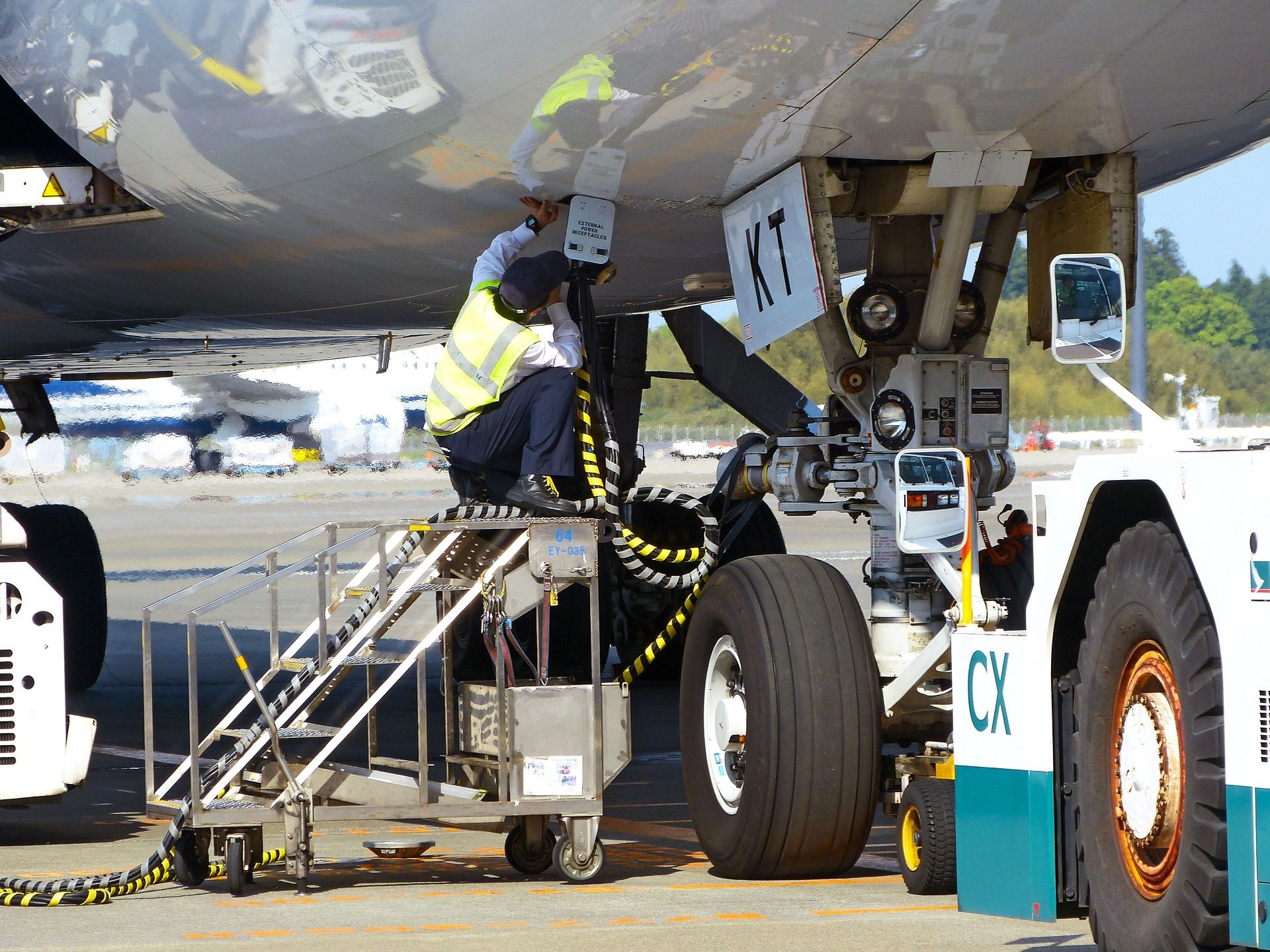 A Ground Worker Servicing A Parked Aircraft. 