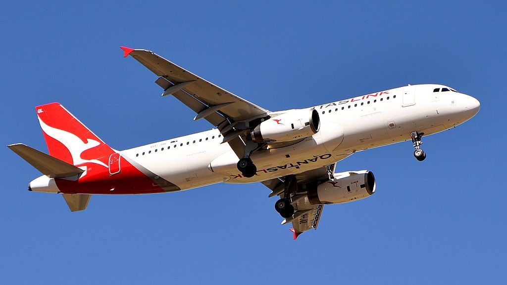 A QantasLink Airbus A320 flying in the sky.
