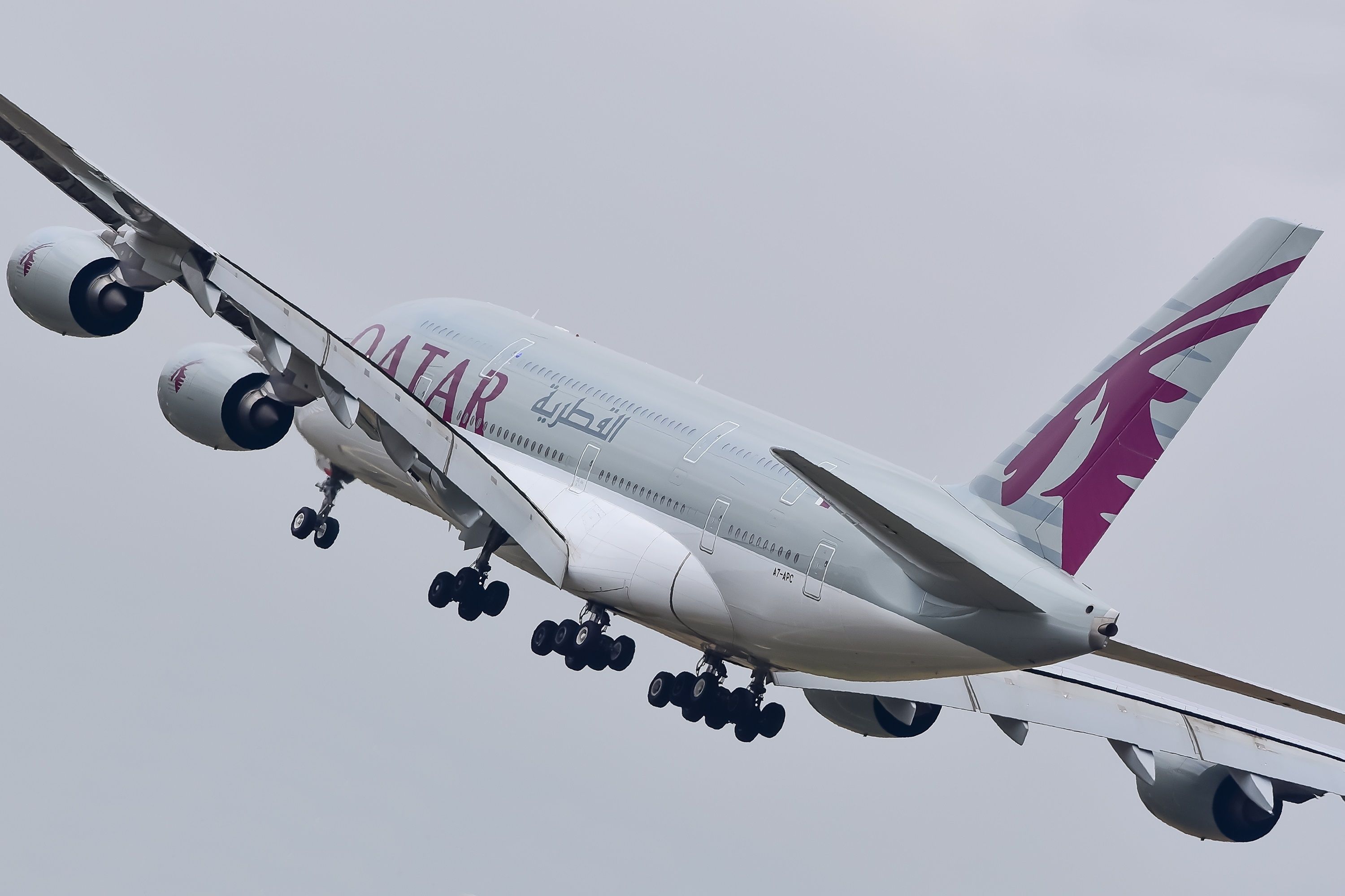 A Qatar Airways Airbus A380 flying in the sky.
