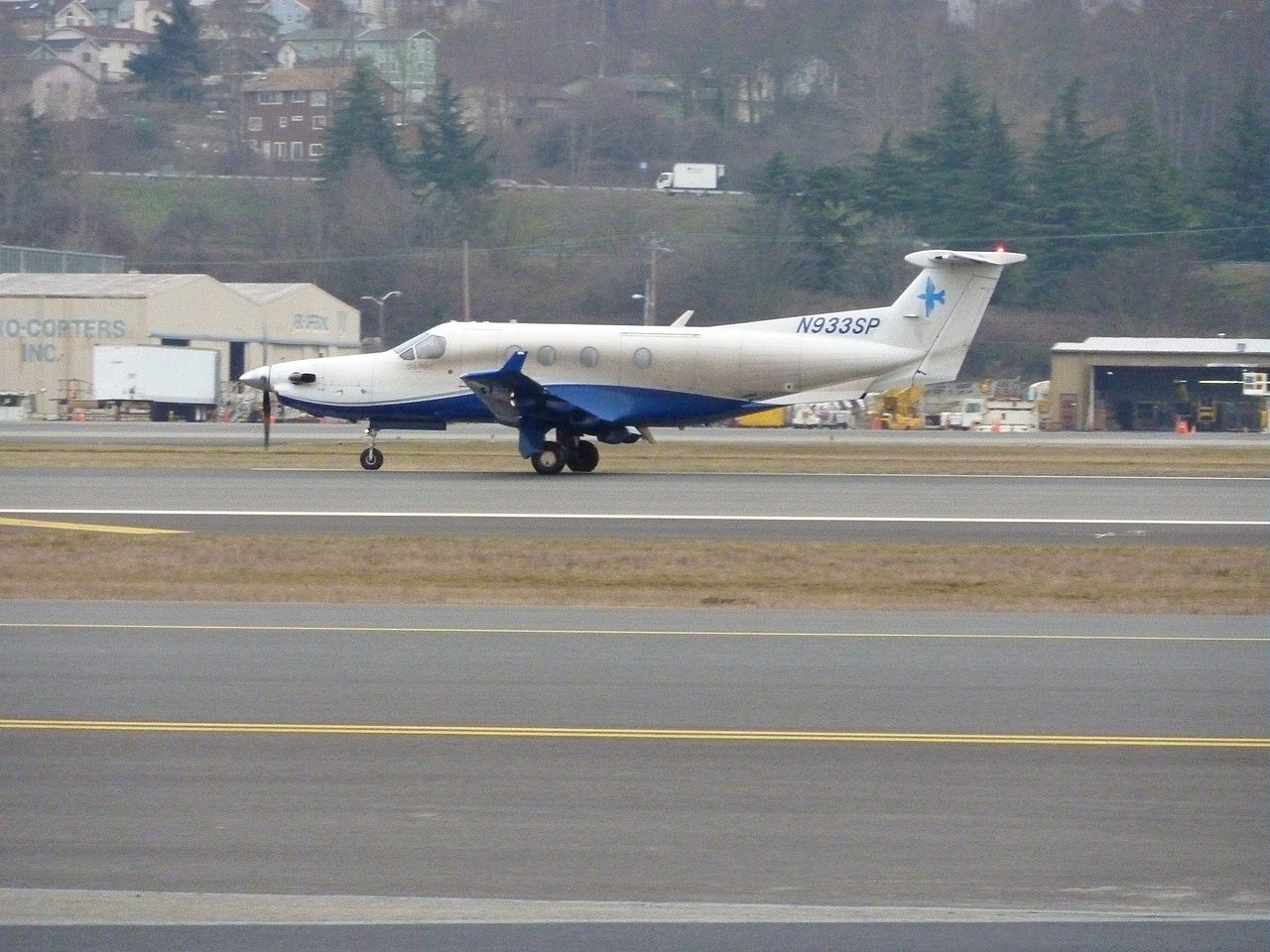 A Seaport Airlines Pilatus PC-12, registration N933SP, on the taxiway.