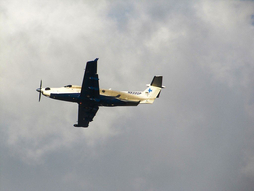A Seaport Airlines Pilatus PC-12, registration N933SP, flying in the clouds.