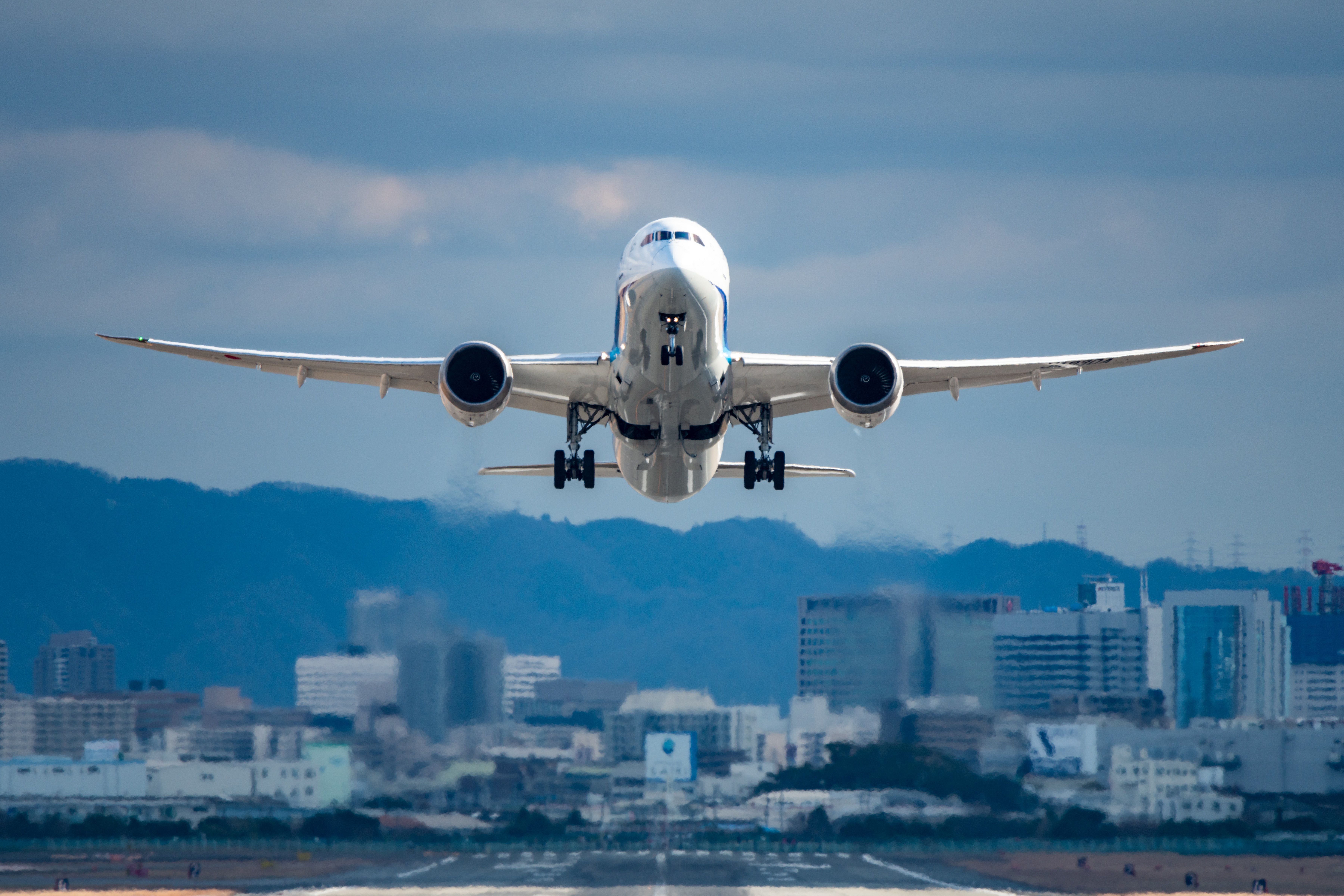 A Boeing 787 taking off from a runway.