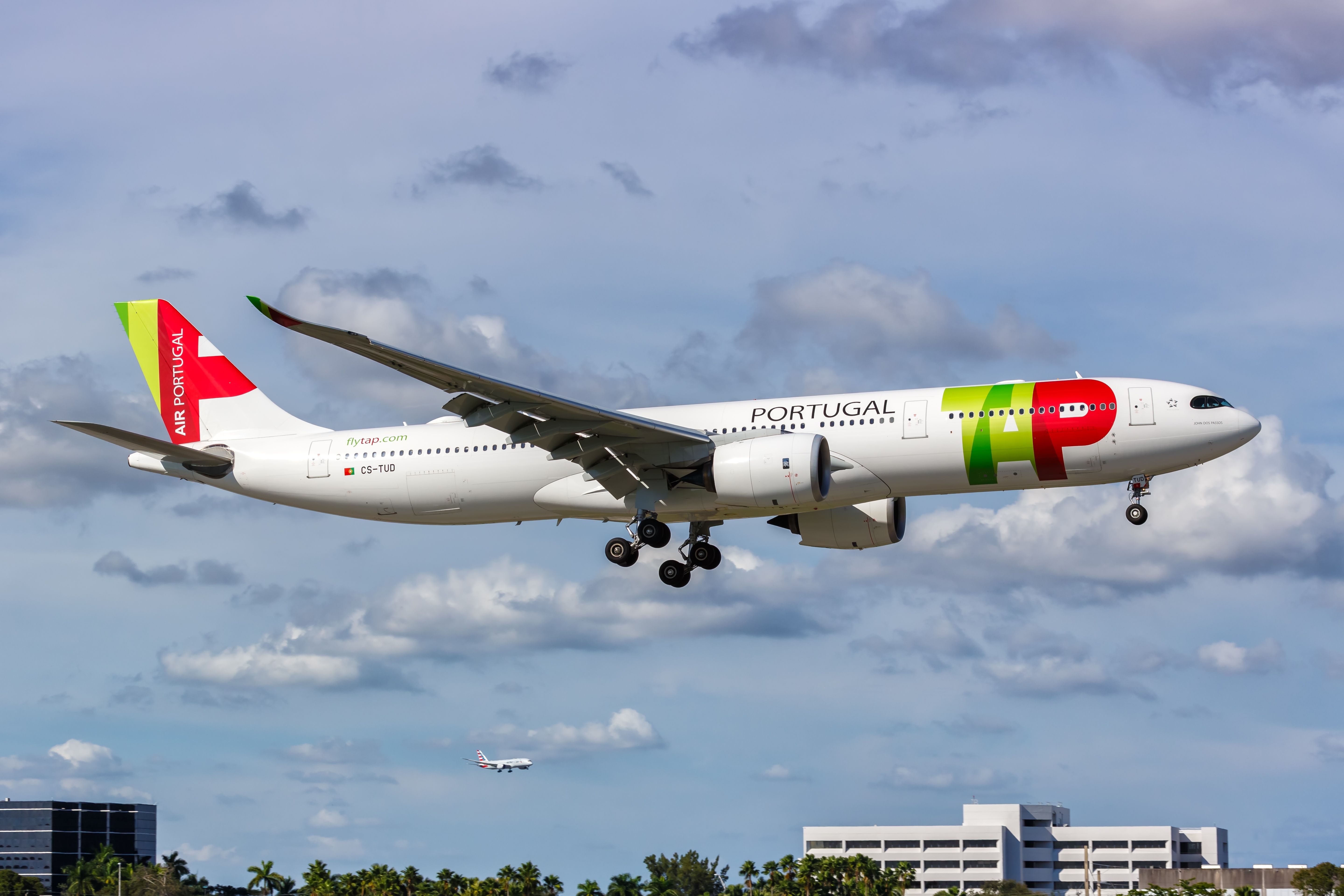 A TAP Air Portugal Airbus A330 flying low close to the ground.