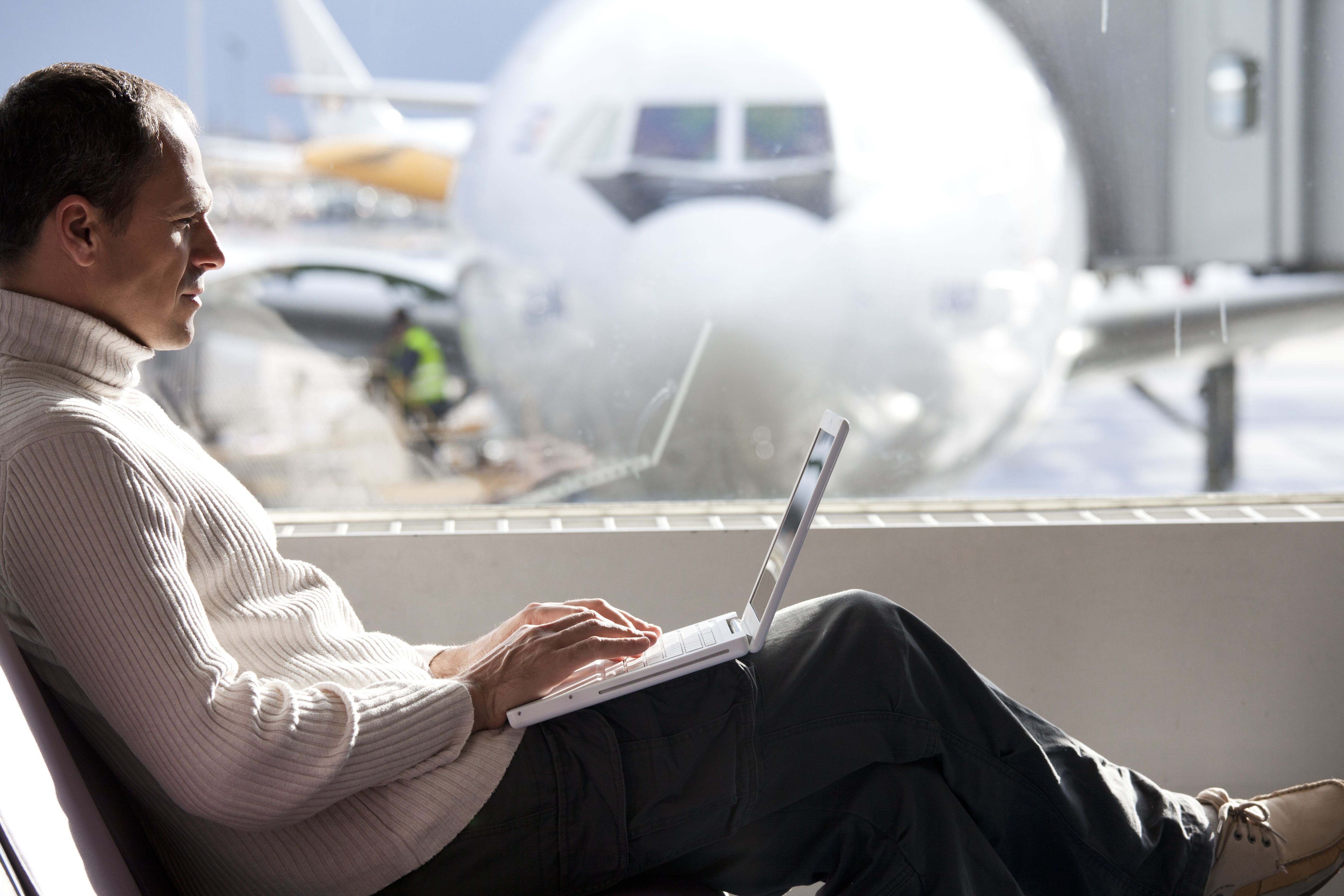 A business traveler sitting at an airport gate.
