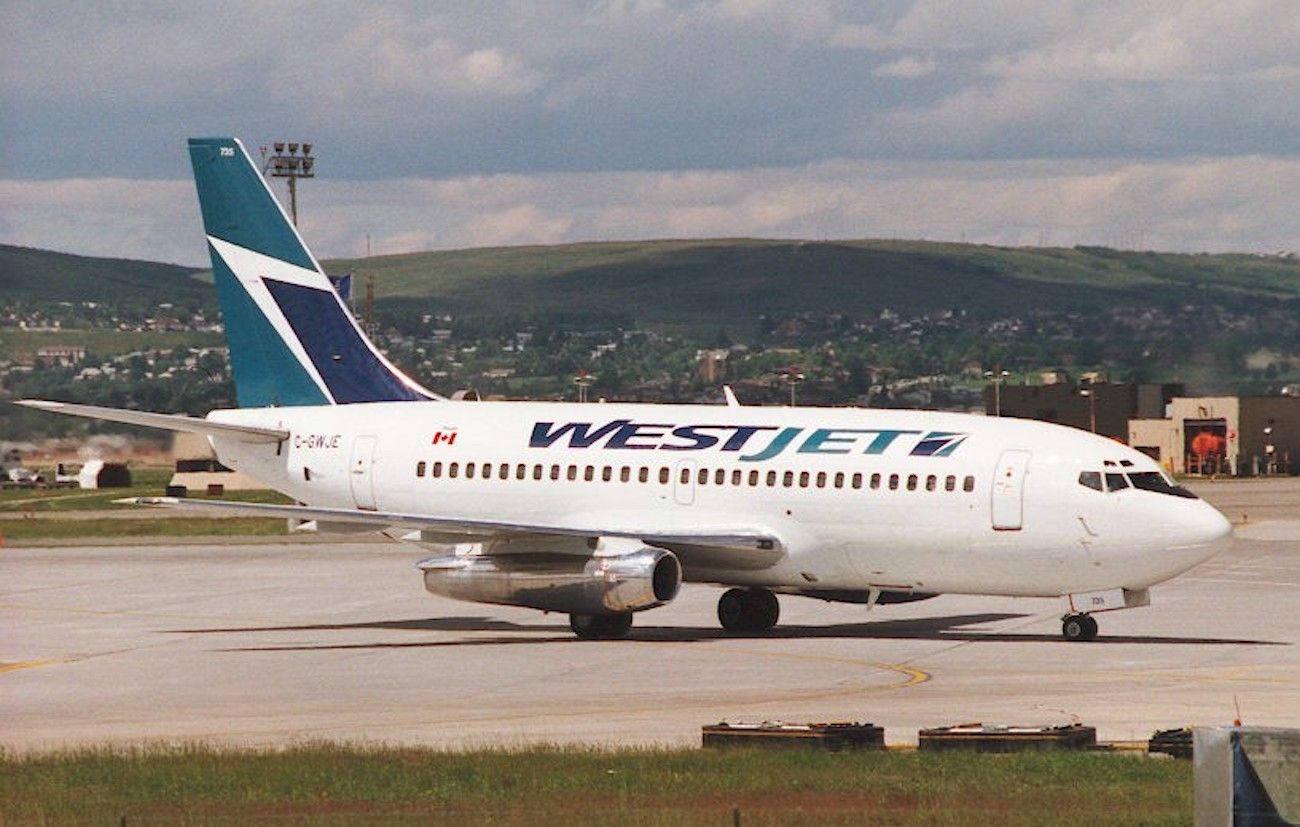 A Westjet Boeing 737-200 taxiing to the gate.