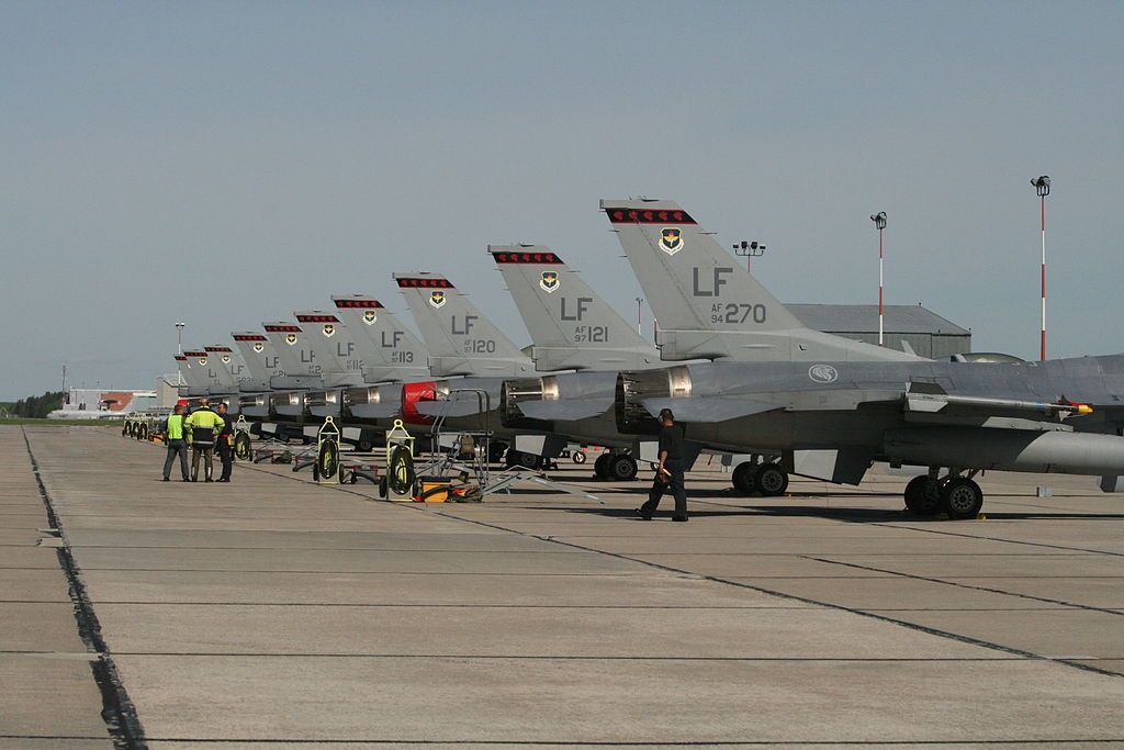 Many Republic of Singapore Air Force fighter jets lined up at an airfield.