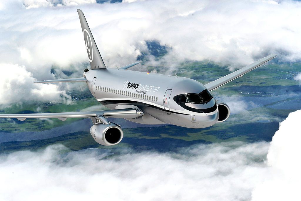 A Sukhoi Business Jet flying in the sky.