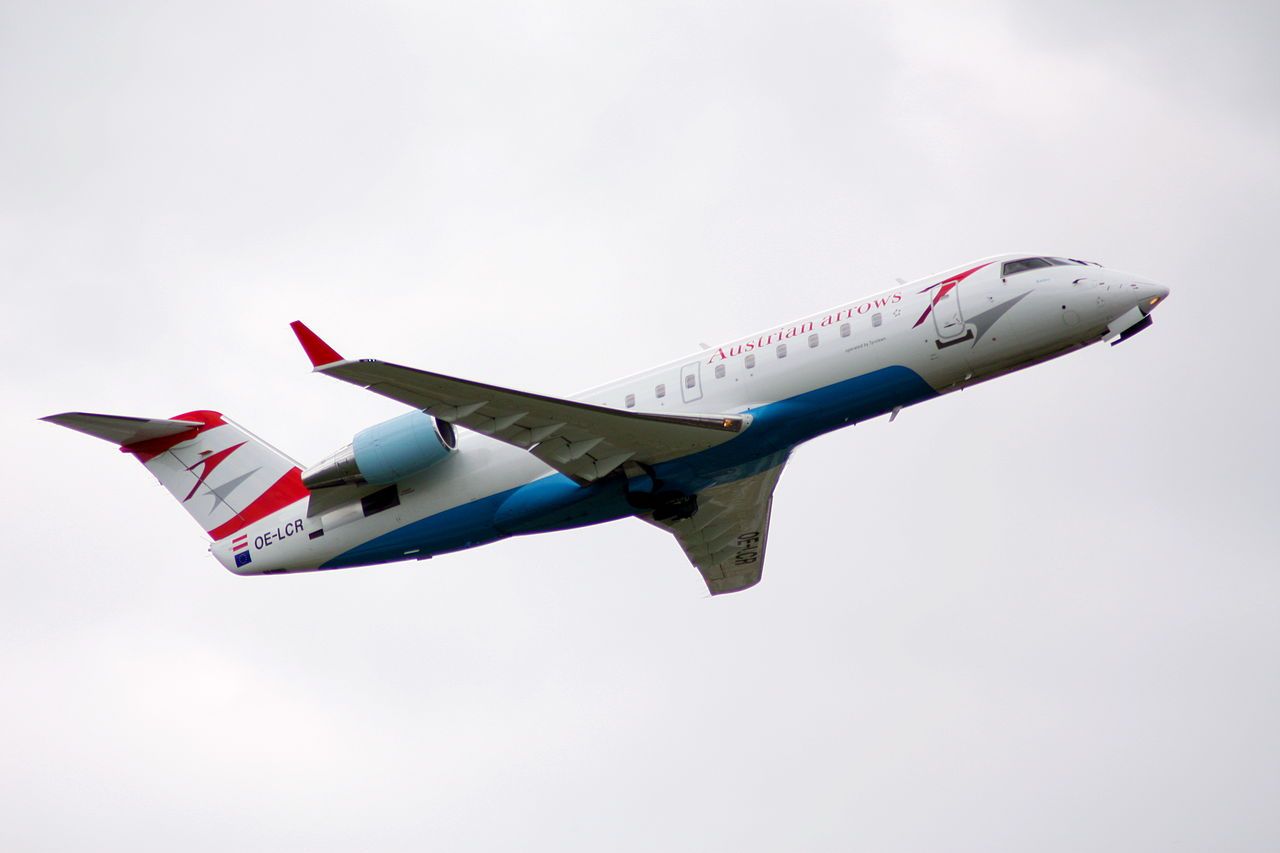 An Austrian Airlines CRJ200 flying in the sky. 