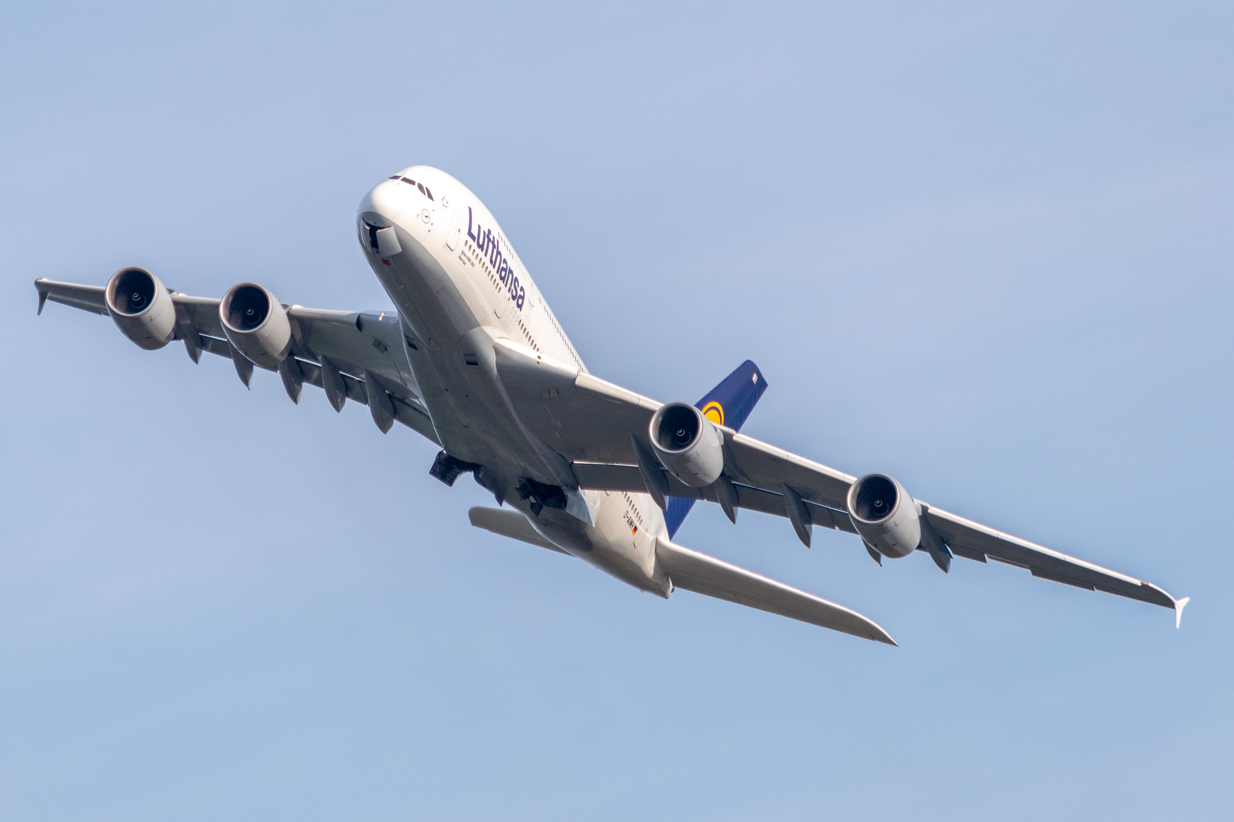 A Lufthansa Airbus A380 flying in the sky.