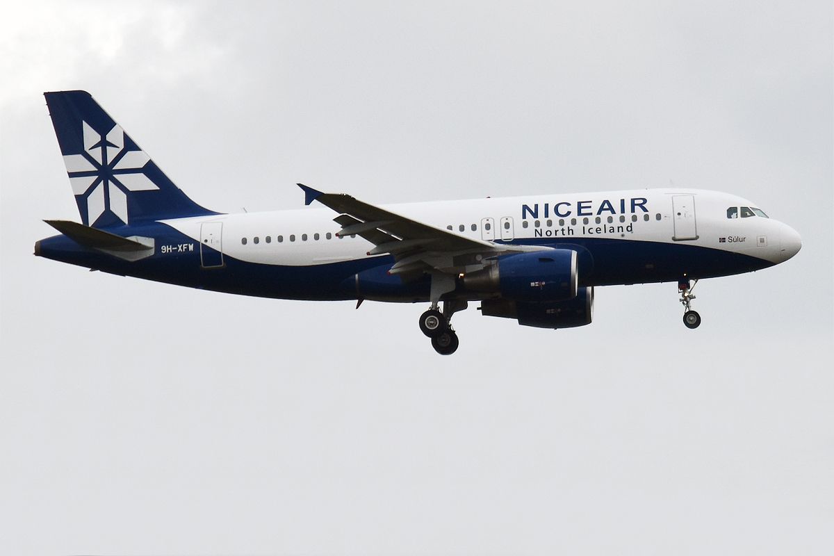A Niceair Airbus A319-112 flying in the sky.