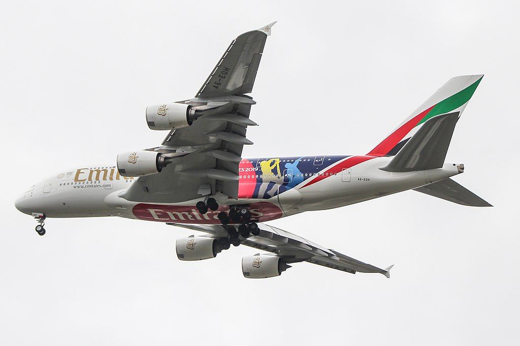 An Emirates A380 with International Cricket Counil Livery flying in the sky.